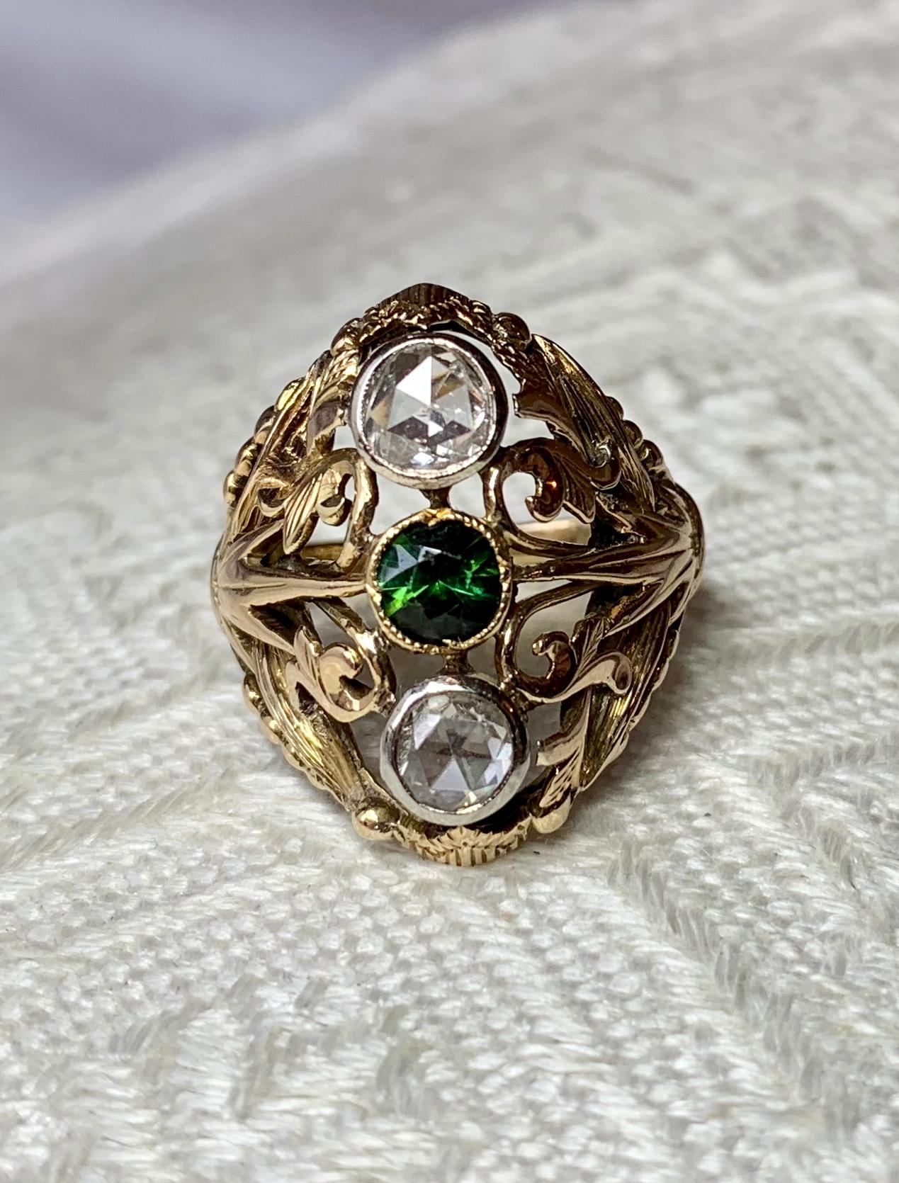 A magnificent original Art Nouveau Ring with a central Fine Green Tourmaline and two stunning Rose Cut Diamonds set in an open work highly detailed setting of great beauty in 14 Karat Gold.  A very unusual Art Nouveau - Belle Epoque jewel with a