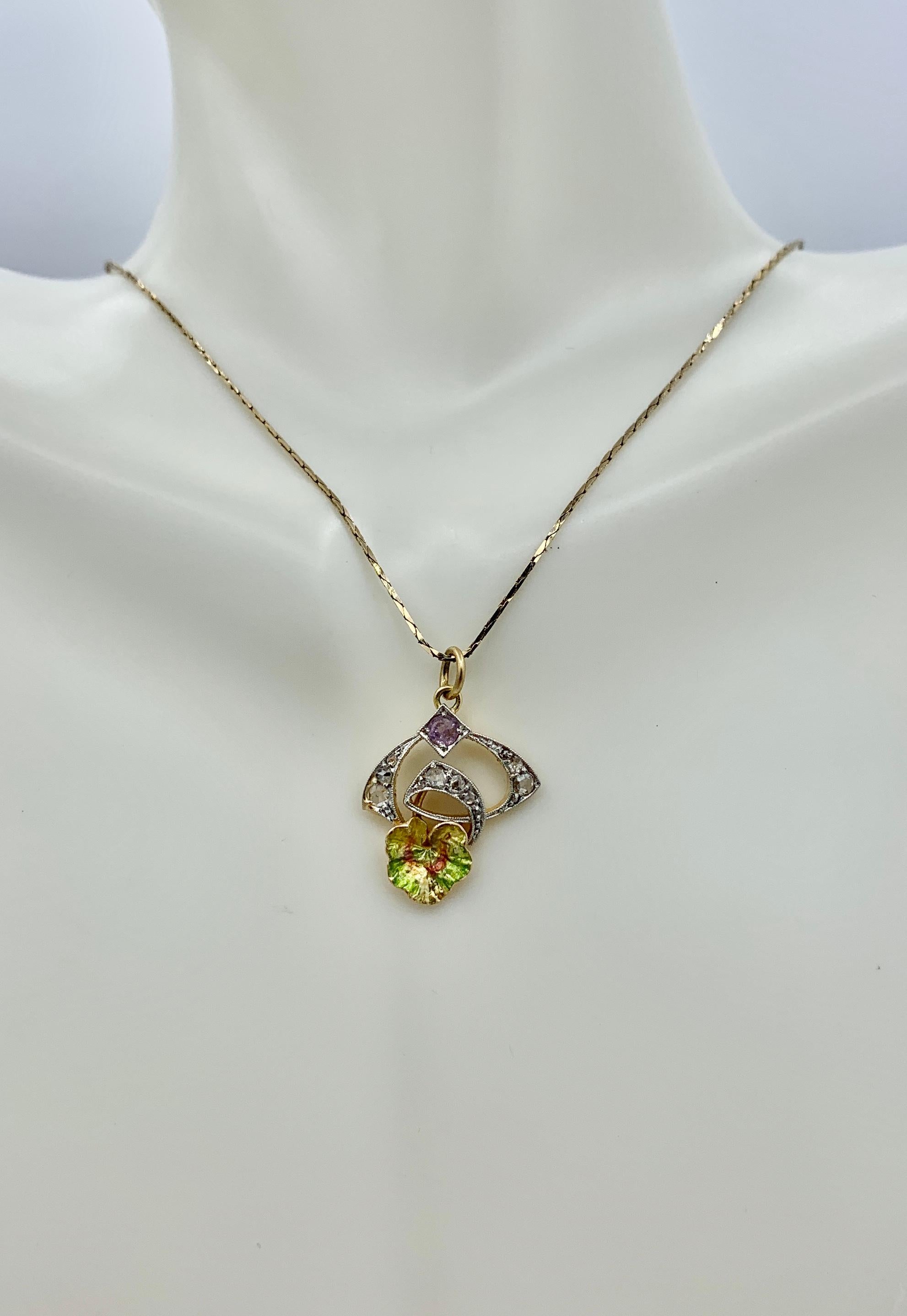 THIS IS A WONDERFUL ORIGINAL ART NOUVEAU PENDANT OR CHARM IN A STUNNING FORM WITH ROSE CUT DIAMONDS, 
 AND AMETHYST, IN 14K WHITE AND YELLOW GOLD WITH A GORGEOUS TRANSLUCENT GREEN ENAMEL LILY PAD LEAF AT THE BASE, AND DATING TO CIRCA 1910.
This is