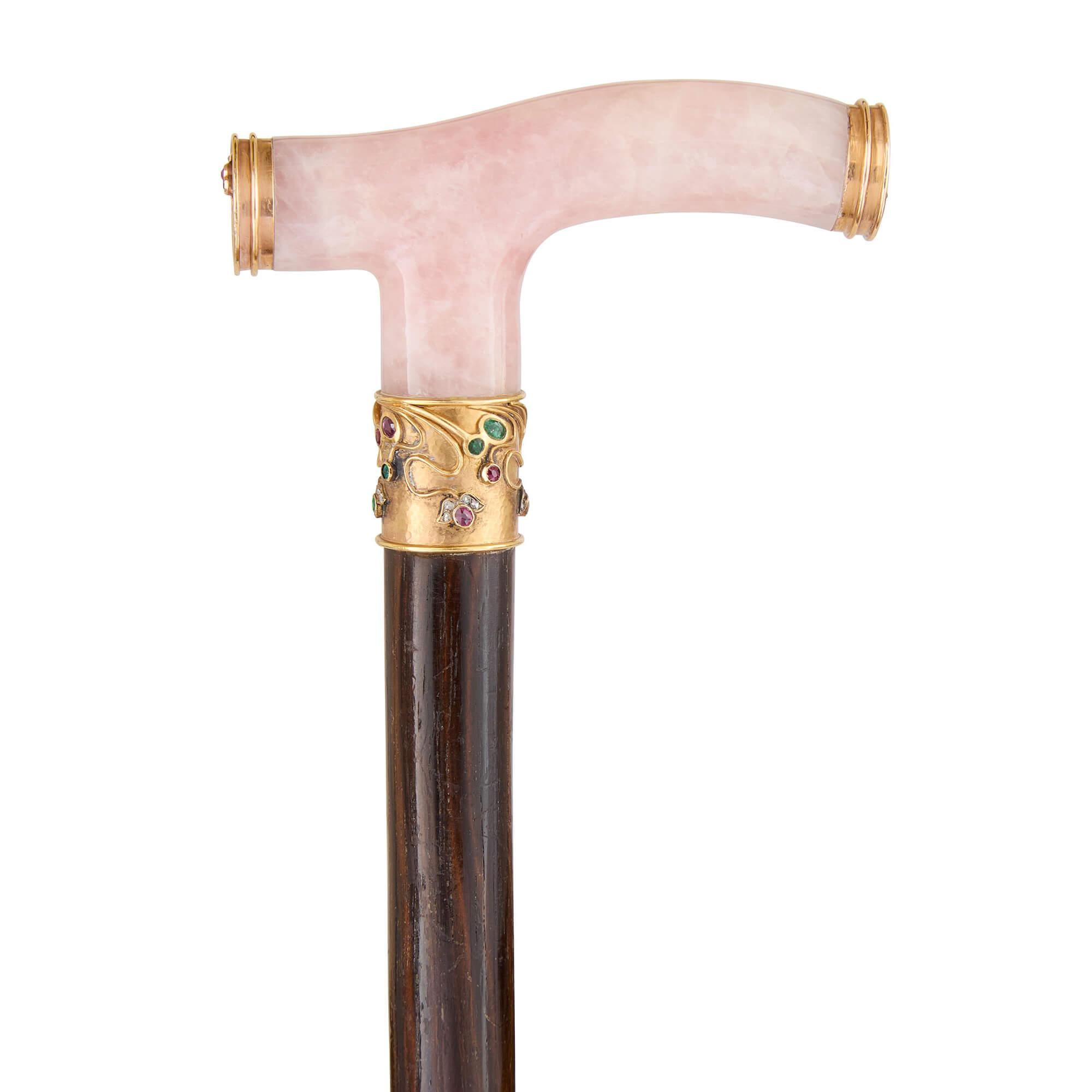 Art Nouveau rose quartz, gold, ruby, emerald and diamond walking stick 
Russian, c. 1900 
Height 91cm, width 7cm, depth 1.5cm 

This superb walking stick, crafted around 1900, embodies the elegance of the Art Nouveau style, which was prevalent in