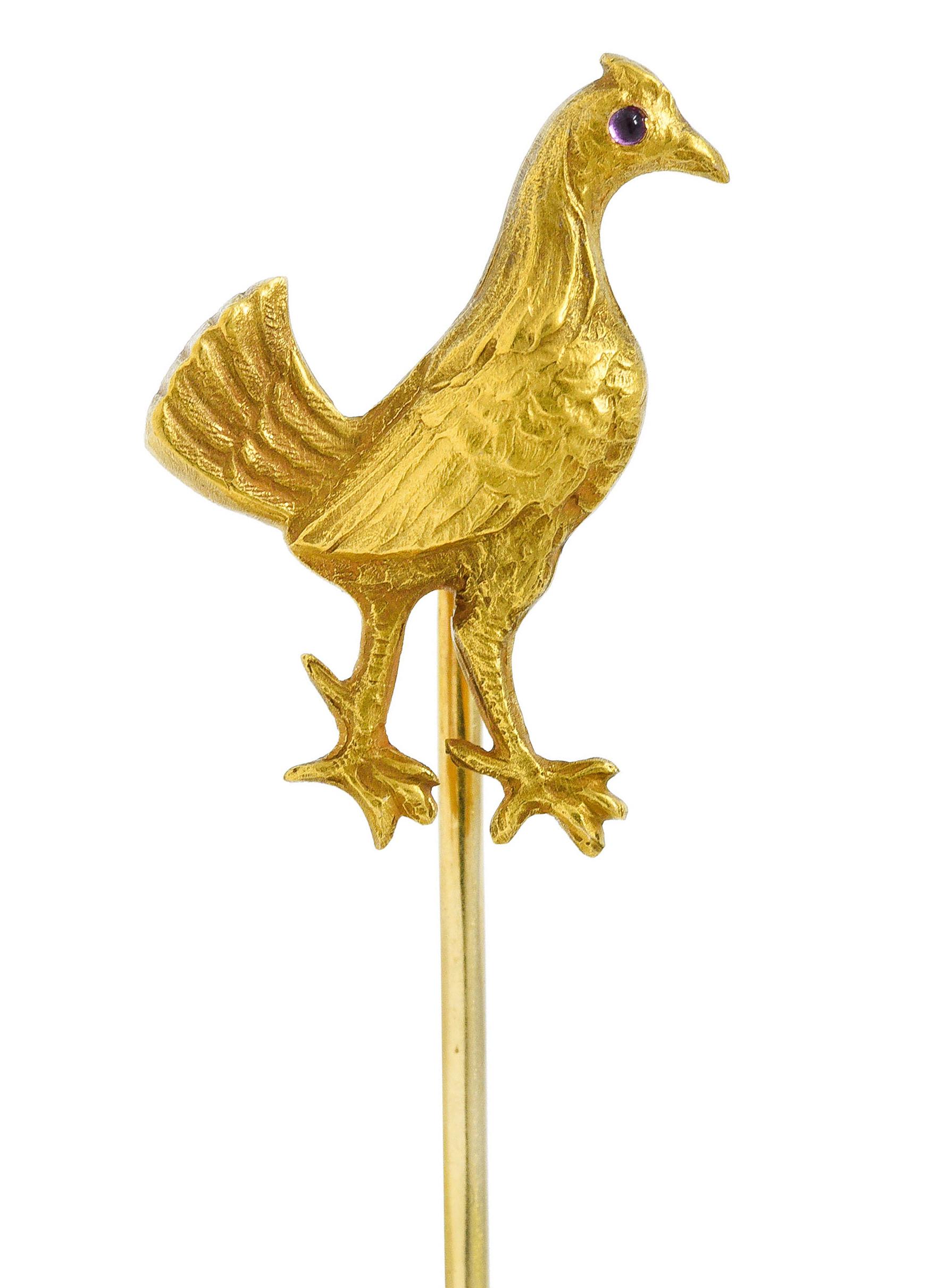 Designed as a strutting quail with a fanned tail and ruby cabochon eye

Feathers are highly rendered and feature a matte finish

Stamped 14K for 14 karat gold

Circa: 1905

Quail measures: 5/8 x 13/16 inch

Total length: 2 11/16 inches

Total