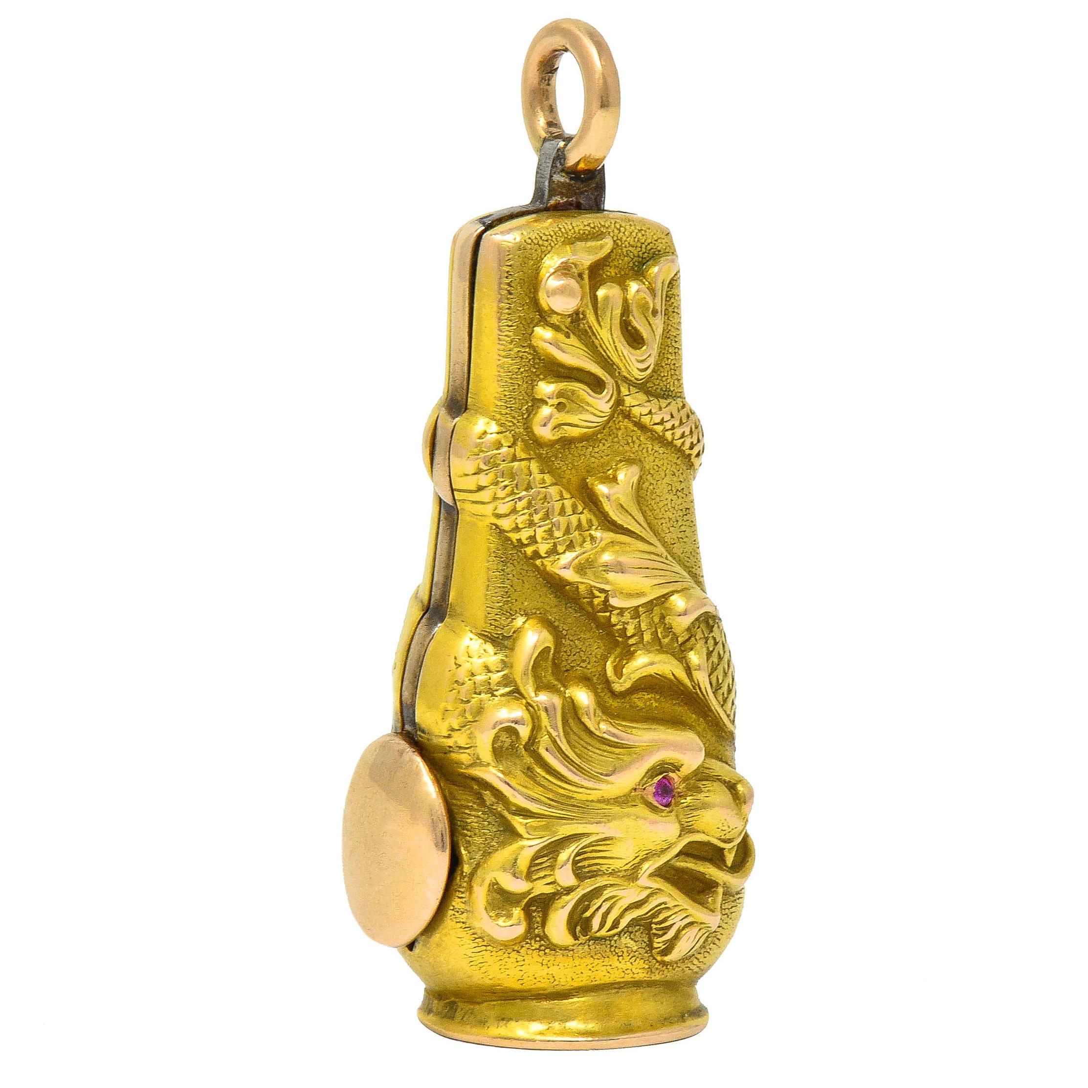 Tubular pendant features a highly rendered serpent dragon design

Its snake-like form wraps fully around the pendant with scale and whiplash details

With two fierce faces accented by ruby accent eyes; purplish-red in color

Terminating as a 10.5 mm