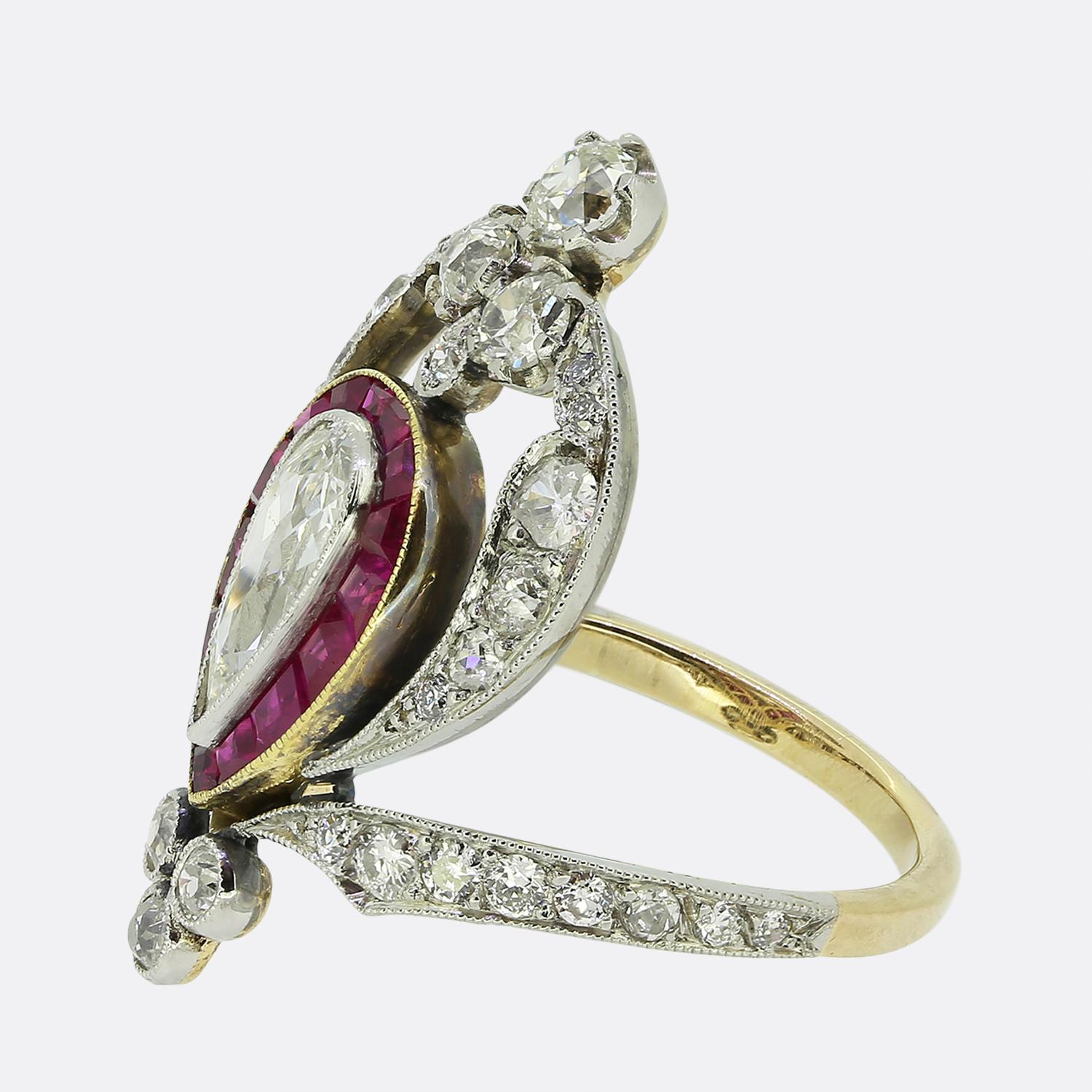Here we have a truly outstanding ruby and diamond dress ring crafted during the Art Nouveau period. A single slim pear shaped diamond sits slightly risen at the centre of the face and is surrounded by a single row of square calibrated rubies