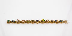 Bracciale Art Nouveau con rubino, zaffiro blu, smeraldo, corallo, peridoto e oro giallo