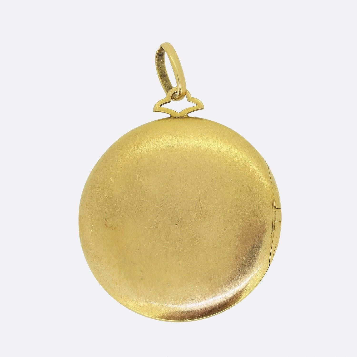 Here we have a charming locket pendant showcasing the fabulous decorative art we have come to associate with the Art Nouveau style and period. This piece has been crafted from 18ct yellow gold into a circular shape and set with a centralised cluster