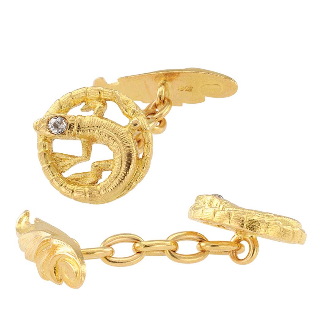Art Nouveau diamond and gold salamander cufflinks circa 1905. The matching faces are designed as salamanders viewed from the top with their long tails wrapped around their bodies in a circular fashion, diamond-set heads, the two diamonds totaling