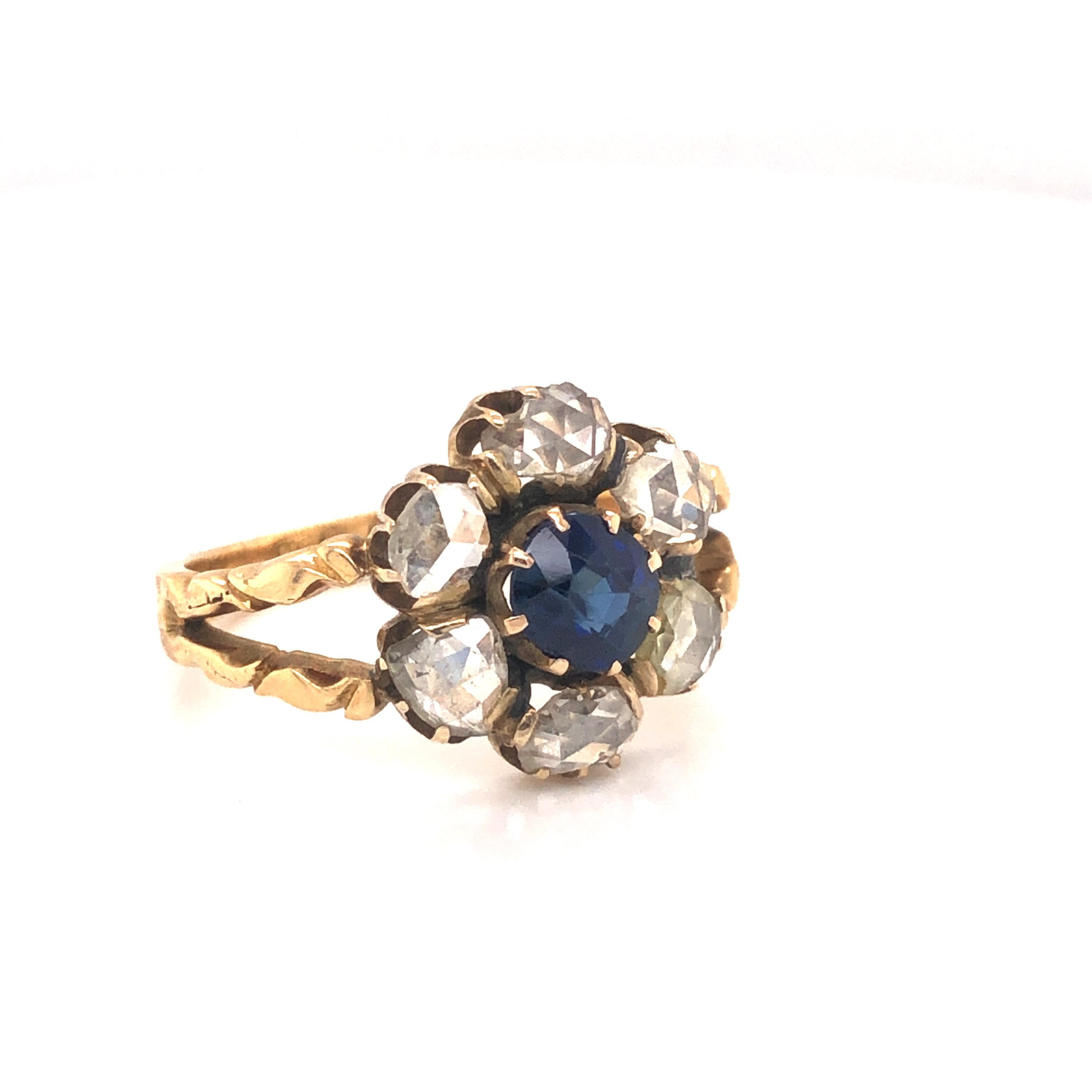 One of a kind vintage treasure. This beautiful ring is crafted in yellow gold. Highlighting the design is one natural  blue Sapphire set in the center. The sapphire  is cushion in shape and  shows an old mine cut. The  stone shows a vibrant blue
