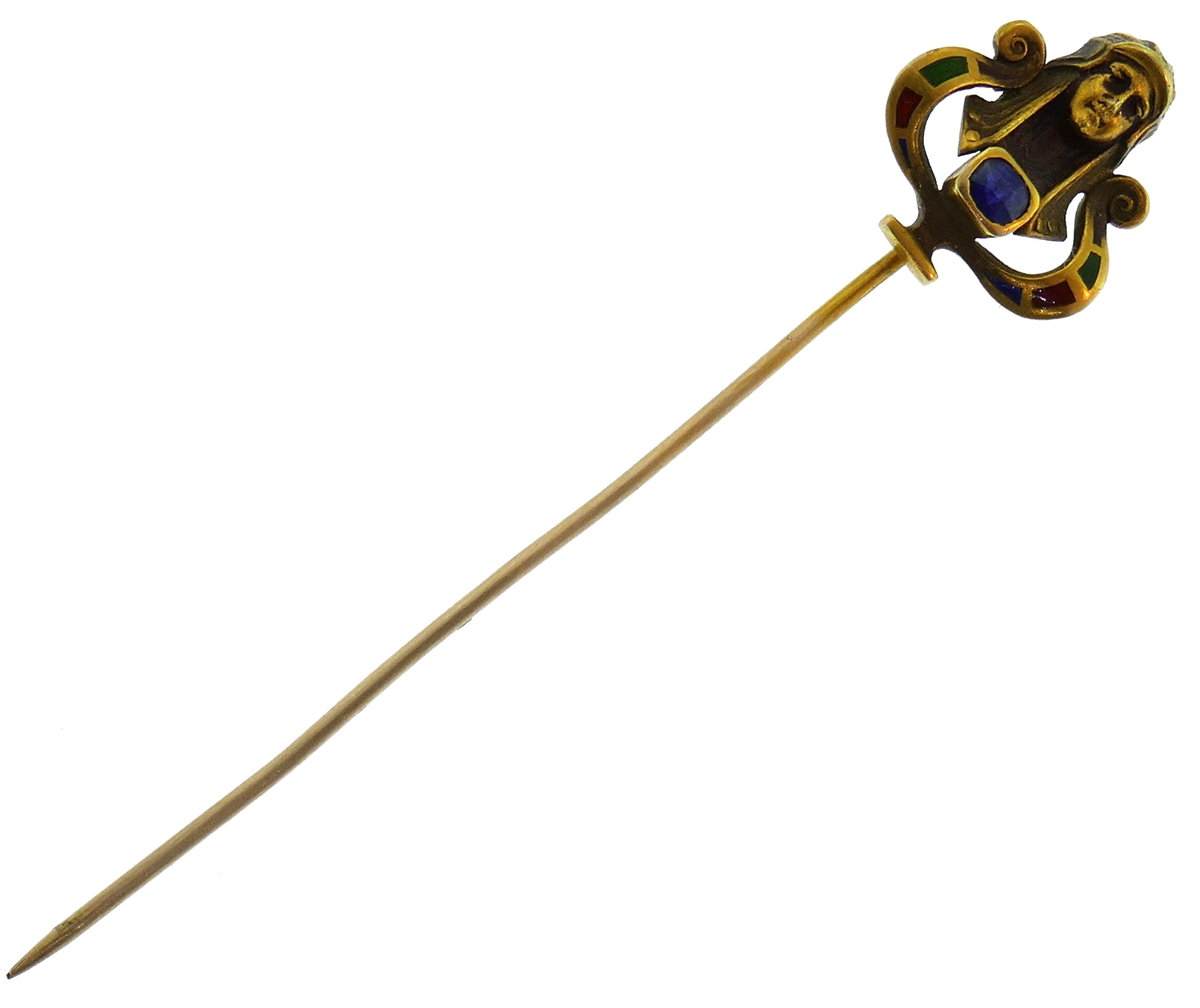 Exquisite Art Nouveau Egyptian revival hat stick pin created in the 1930s. It has a cushion cut blue sapphire set in 14 karat (stamped) yellow gold and accented with colored enamel.
The stick pin measures 2-5/8 x 1/2 inches (6.7 x 1.4 cm) long and