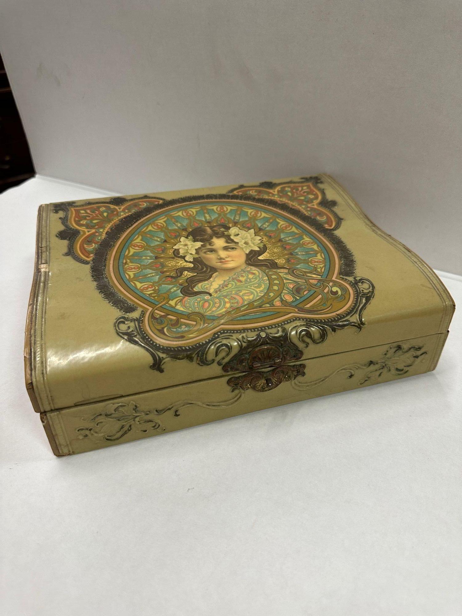 Art Nouveau Jewelry Pink Satin Lined Box, the woman is depicted with flowers in her hair and pink cheeks.
Box has Evidence of wear over time, the back enamel lining is flaking off.

Art Nouveau was an influential artistic movement that flourished in