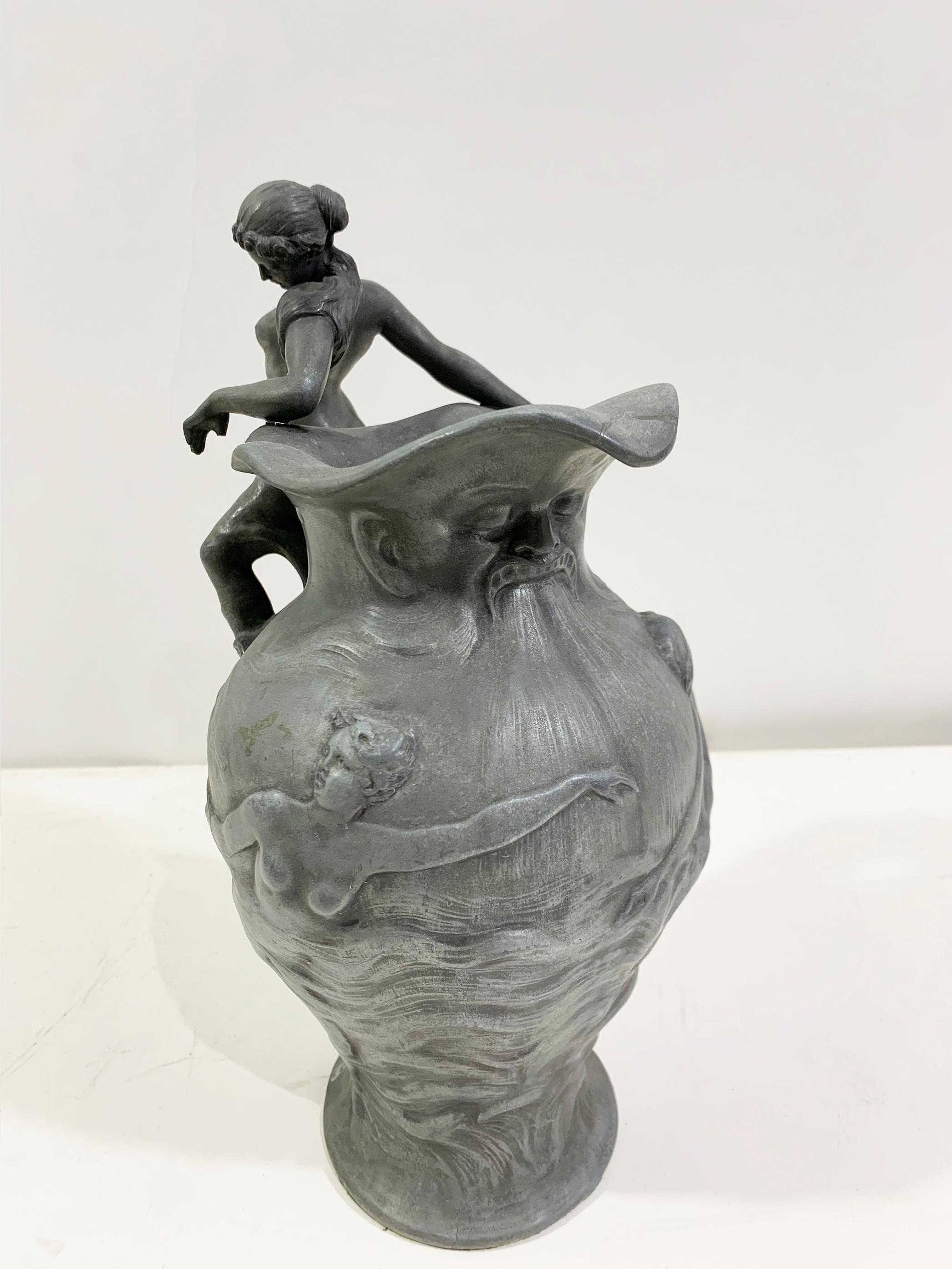 The Art Nouveau sculptural pitcher by sculptor Charles Théodore Perron (1862-1934) is a testament to the elegance of Art Nouveau craftsmanship.

Crafted in France around 1900's, this pewter showcases Perron's keen eye for detail and artistic flair.