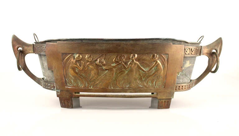 Antique Art Nouveau Jardiniere/centerpiece, circa 1870-1880. The overall shape seems to be taken from a viking drakkar with the mooring rings and celtic symbols, while the center theme featuring a circle of woman holding hands and dancing.
The