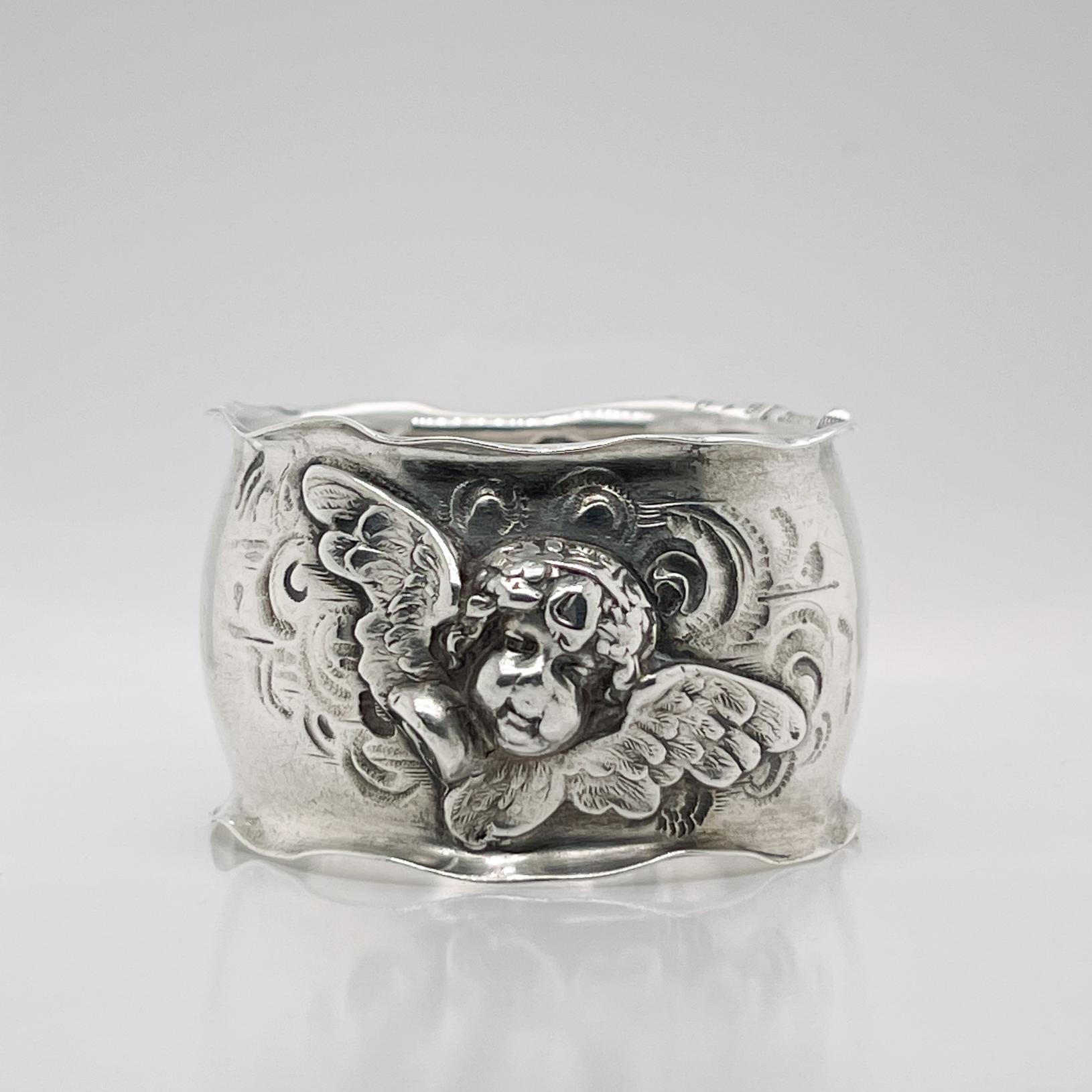 A fine antique Art Nouveau napkin ring

By the George Shiebler Silver Company of Baltimore, Maryland.

With raised winged cherub or putti heads to both the front and back (seemingly after the cherubs in Raphael's Sistine Madonna painting).

Simply