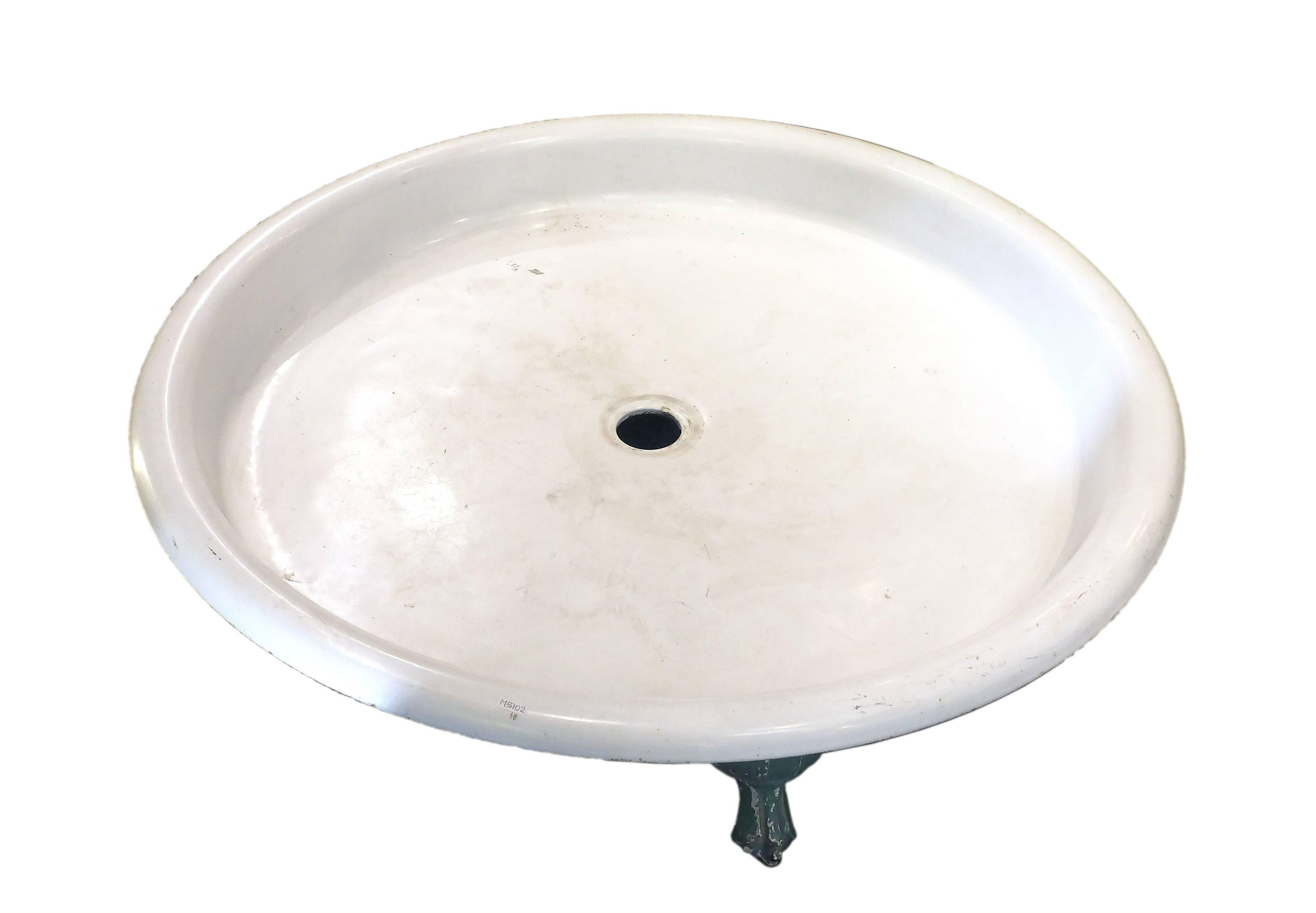 A beautiful and unusual round shaped shower tray in white cast iron with four feet in the shape of a paw. Cast iron, green painting in the front, France, circa 1900.