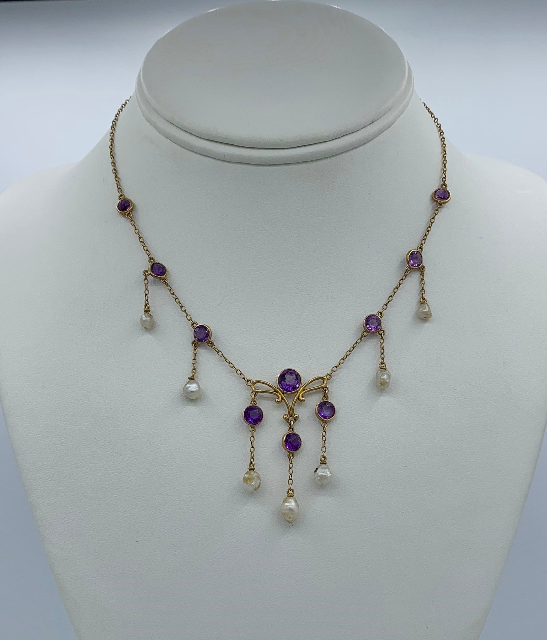 THIS IS A STUNNING VICTORIAN - ART NOUVEAU - BELLE EPOQUE NECKLACE WITH THE MOST GORGEOUS NATURAL ROUND FACETED SIBERIAN AMETHYST GEMS SET IN A WONDERFUL PENDANT DROP DESIGN WITH NATURAL PEARLS IN 14 KARAT GOLD.
This antique pendant necklace is such