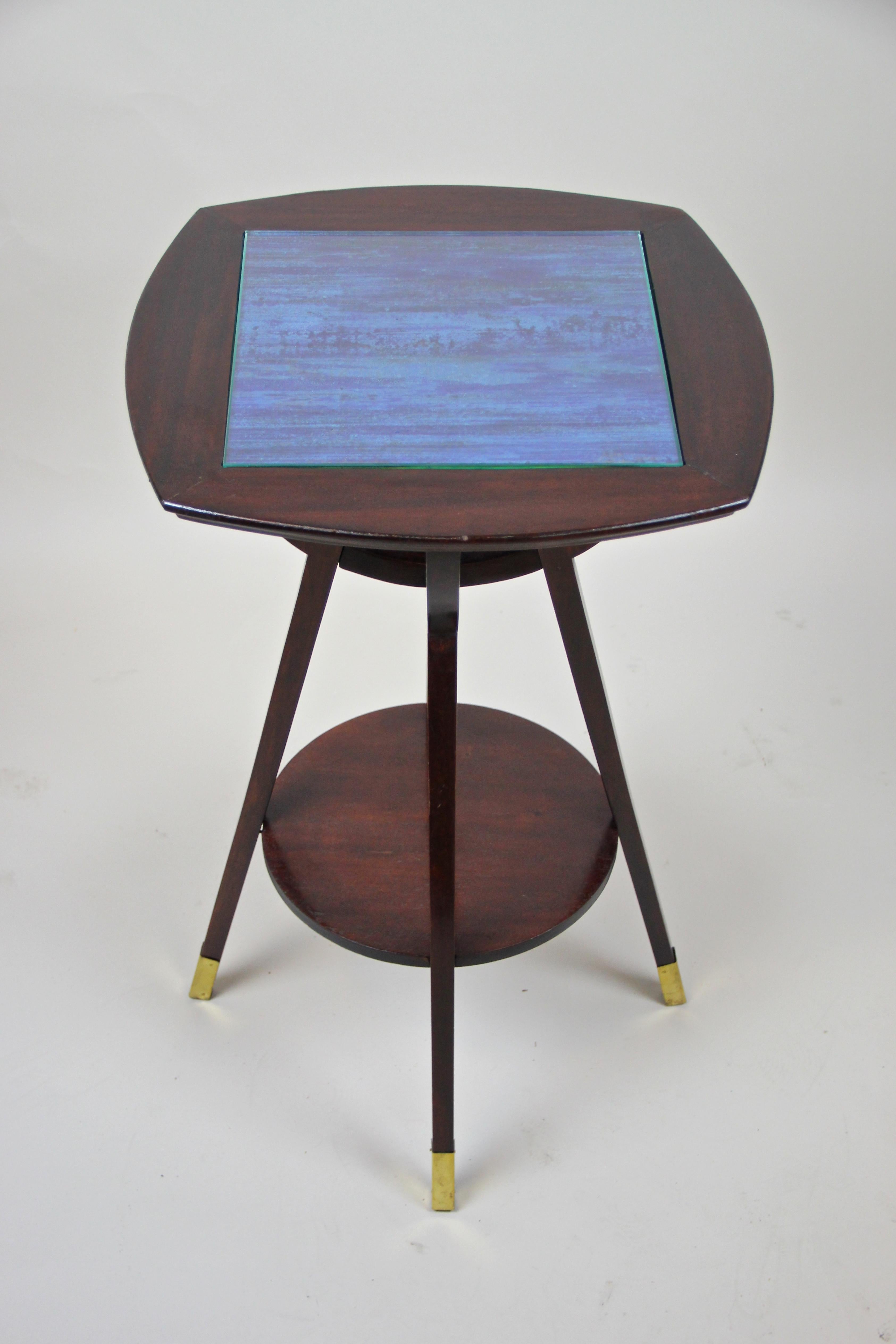 Wonderful designed Art Nouveau side table from the early 20th century, circa 1910. From the flourishing of the Art Nouveau period in Austria comes this beech wood table which was trimmed to a mahogany look. The top plate as well as the floating
