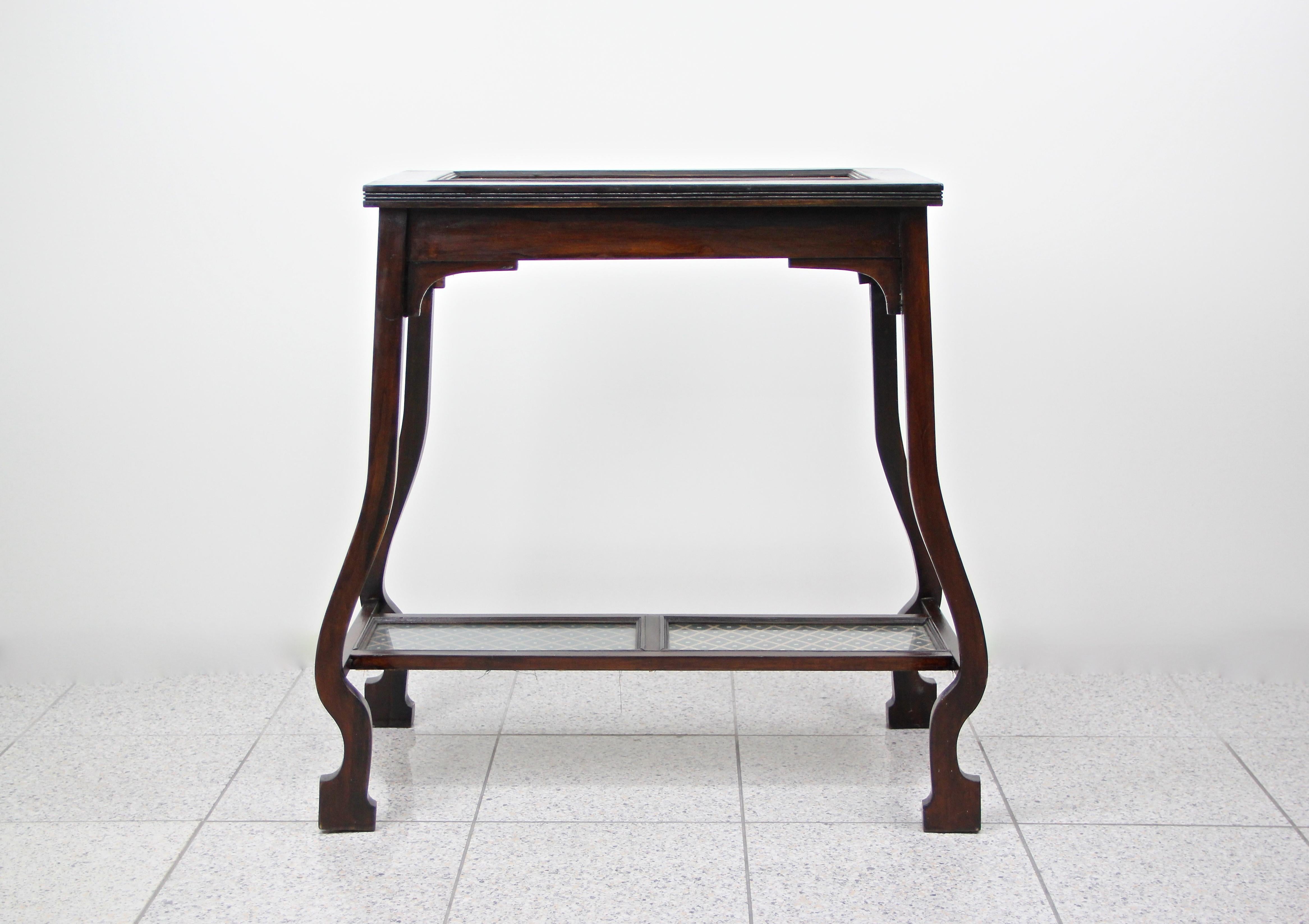 Unusual Art Nouveau side table from the early 20th century in Austria. From circa 1910 the prime of the Art Nouveau period comes this unique designed beech wood table, trimmed to a beautiful dark brown nearly black tone. The top plate as well as the