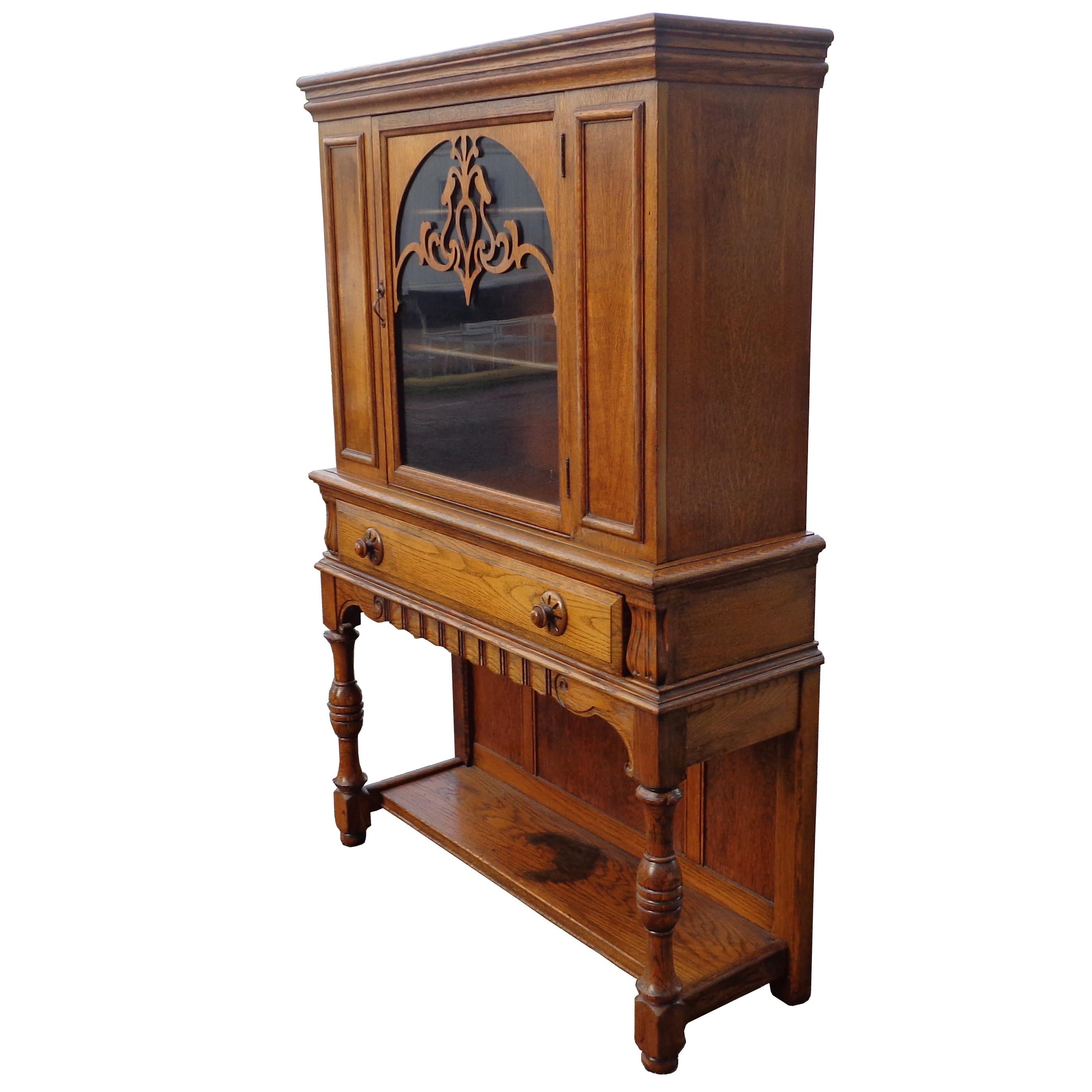 Art Nouveau display cabinet by Limbert Van Raalte Craftsman Furniture
American, 1920s


Beautiful example of Arts & Crafts cabinet. Art Nouveau appliques' on glass and carved pulls. 
One large drawer with dove tail joints and shelving