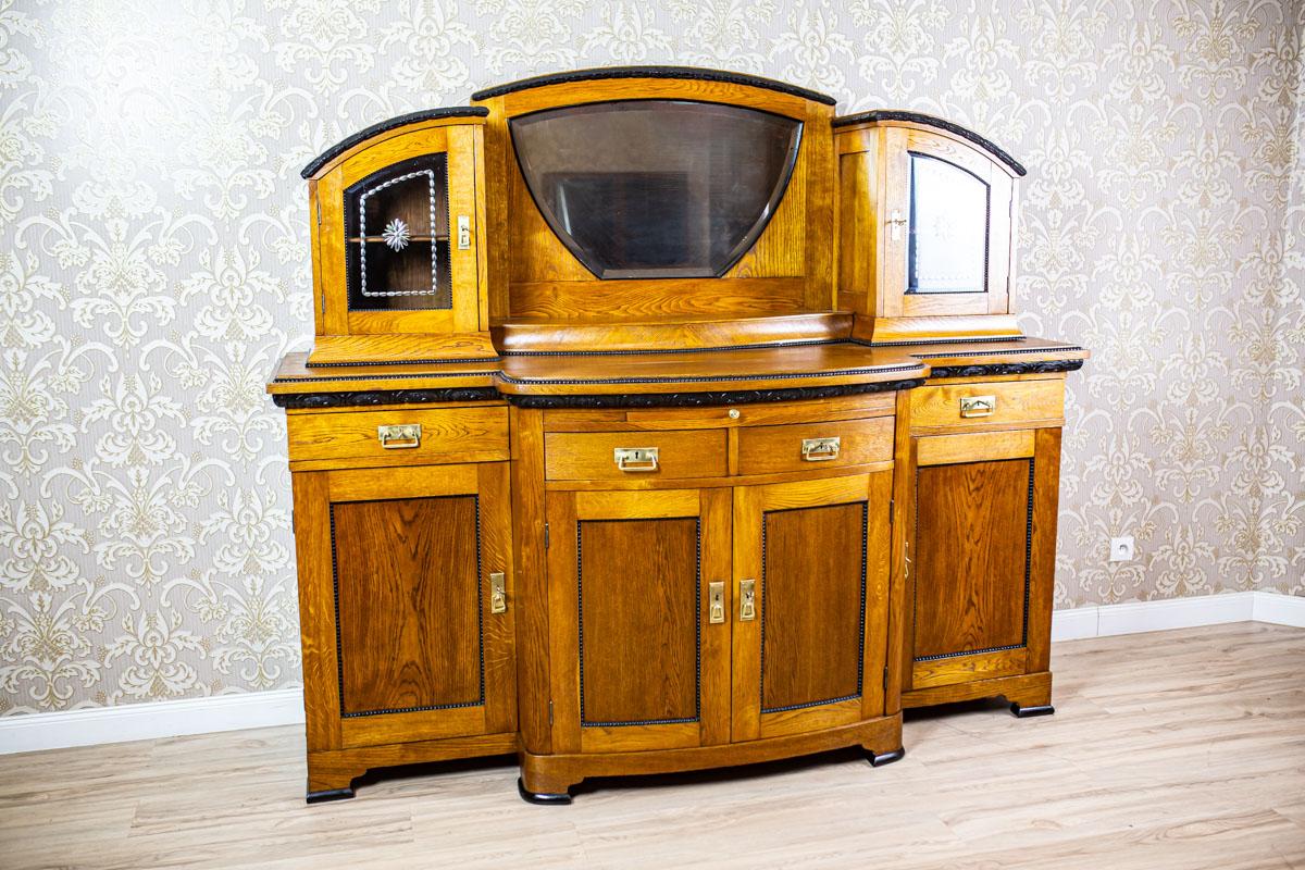 Art Nouveau Sideboard Veneered with Oak, the Turn of the 19th and 20th Century

We present you a big, representative oak and oak burl sideboard from the turn of the 19th and 20th centuries.
This piece of furniture is composed of a four-leaf base,