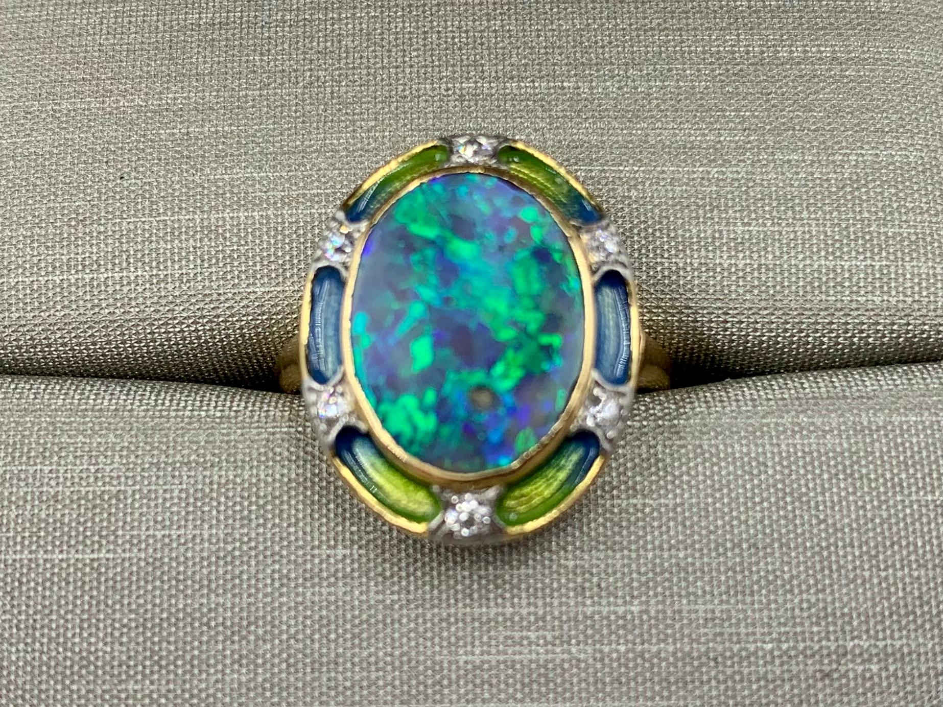 Entrancing Art Nouveau period black opal, diamond, ombre enamel 18k gold ring by Durand & Co. 
The dramatic oval opal framed in an exquisite ombre enamel paneled frame set with six European cut diamonds. The unusual translucent shimmering enamel