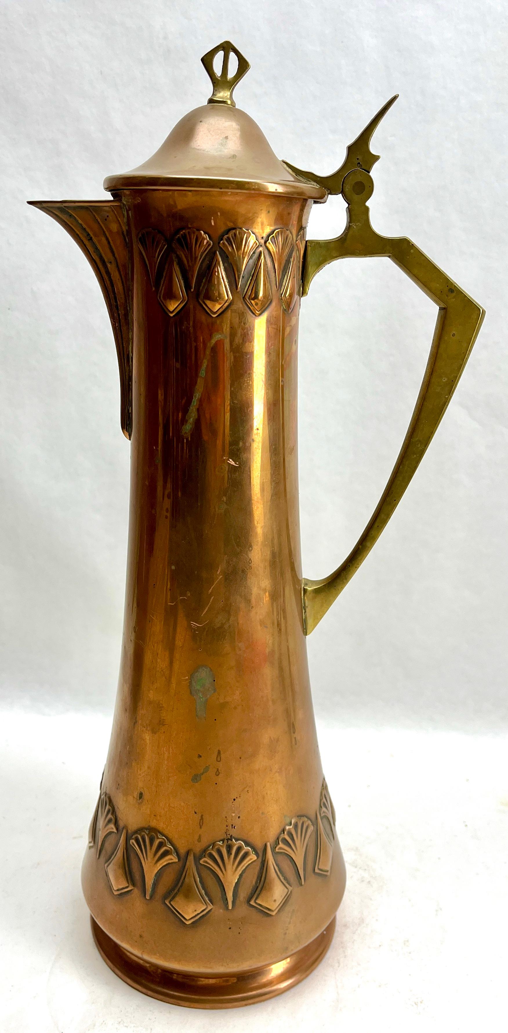 Art Nouveau Signed WMF Pitcher Brass and Copper  with Handle and Organic Details
Hand-hammered out of one piece of copper.
Brass handle with Organic style details

With original Patina on all the parts.
We Prefer to sell our items in 'uncleaned'