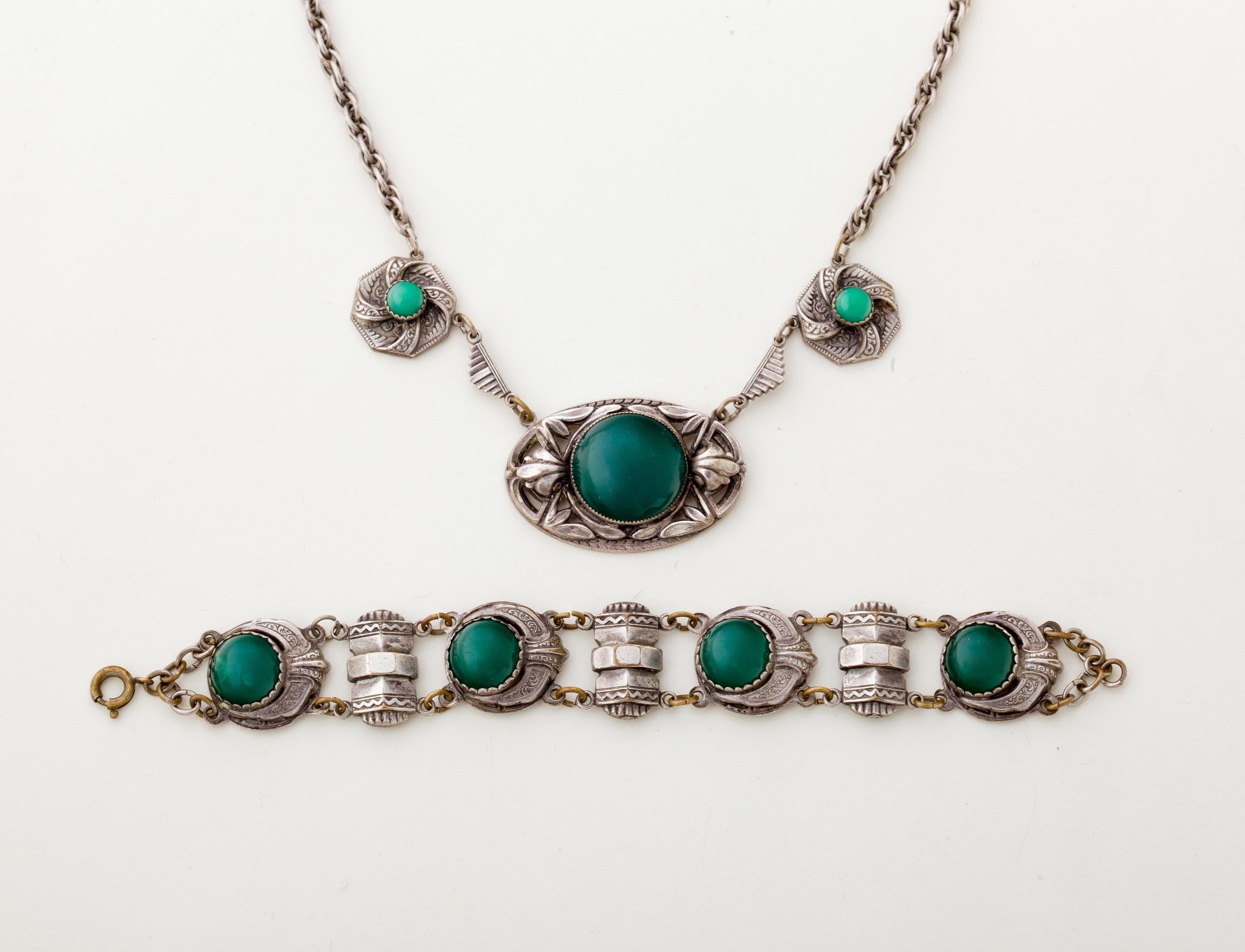 Stunning with beautiful details is this European Art Nouveau Necklace and bracelet with green cabochon stones and most likely a chromium finish on the bracelet and silver plate on the necklace medallion.  Unsigned.  This a great example of Art