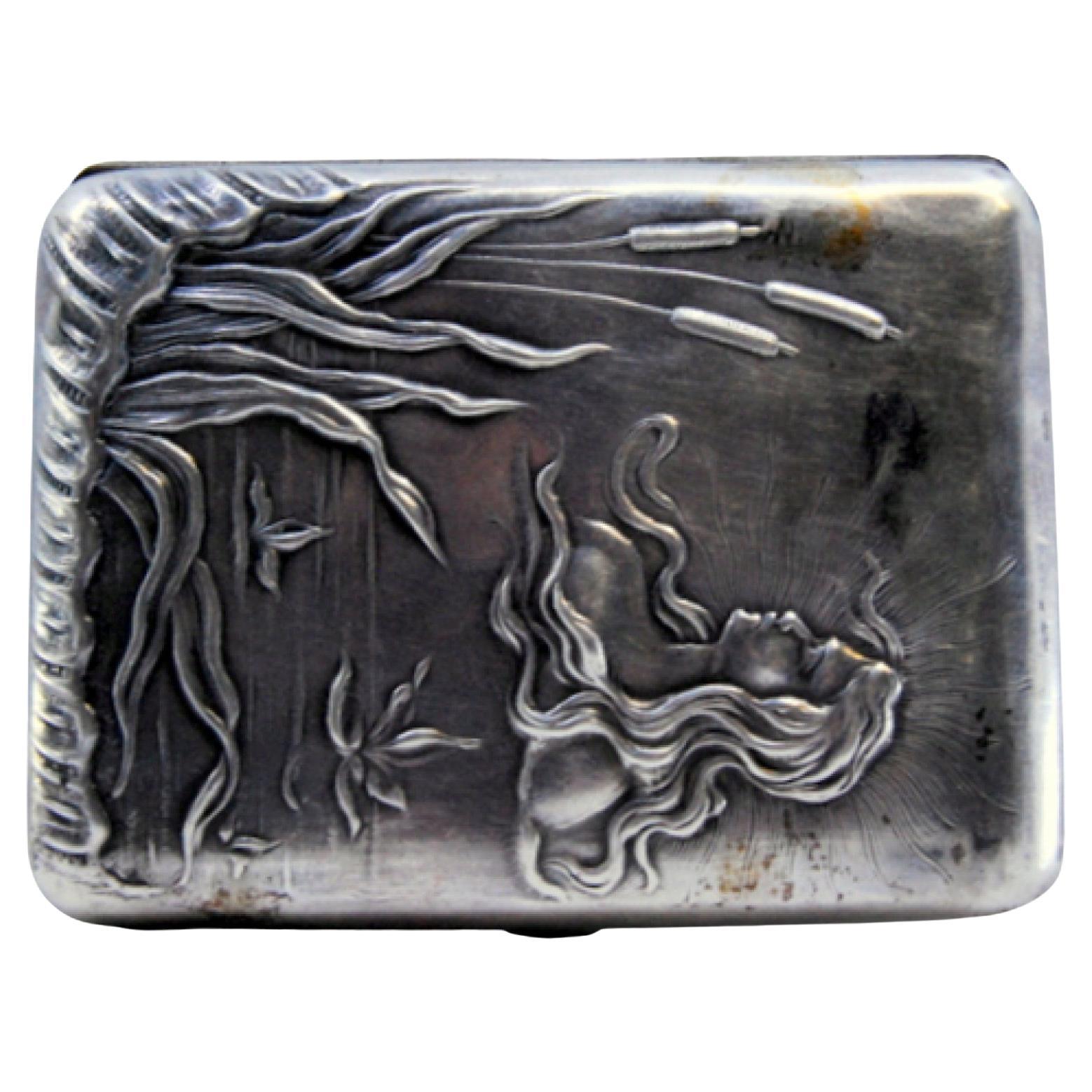 Art Nouveau silver case embossed with young man and floral motifs