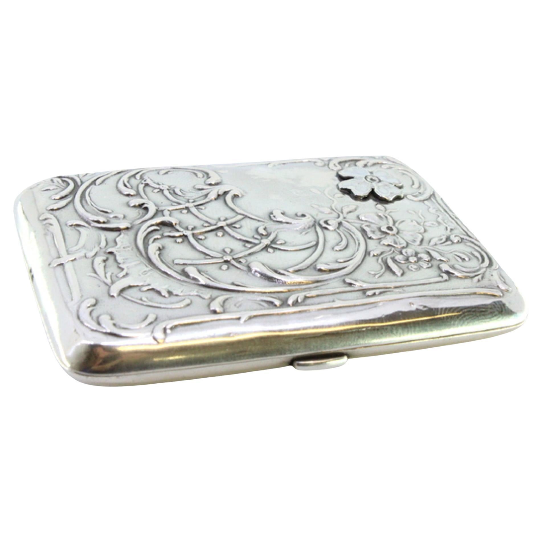 Art Nouveau silver case with embossed florals and gold interior