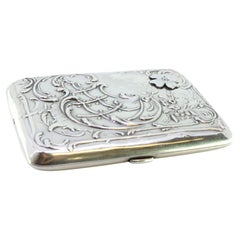 Art Nouveau silver case with embossed florals and gold interior