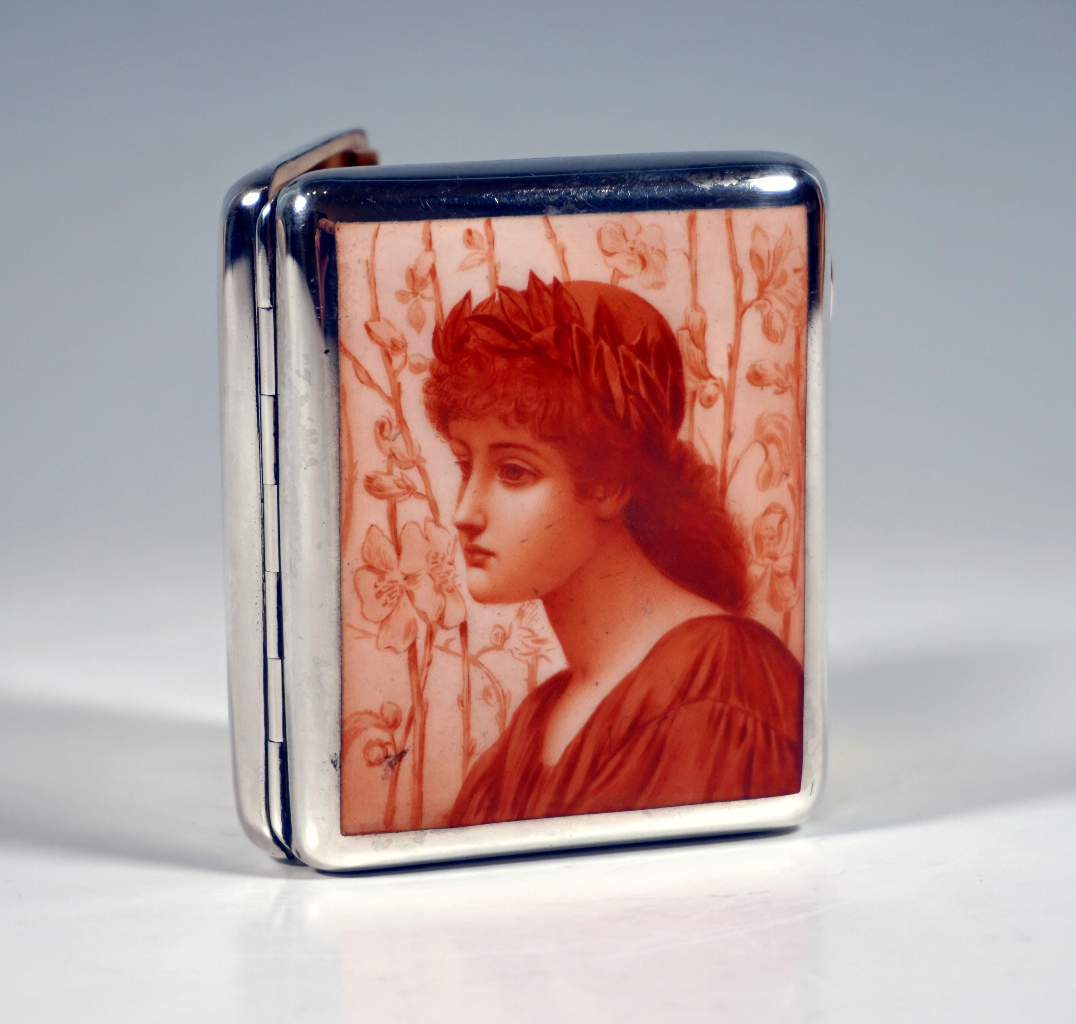 Exquisite Austrian Art-Nouveau Tabatière, Around 1900:
Rectangular smooth silver cigarette case with hinged lid, iron-red camaieu enamel painting on top: portrait of a girl with laurel wreath, opening with snap fastener on the side, eyelets on the