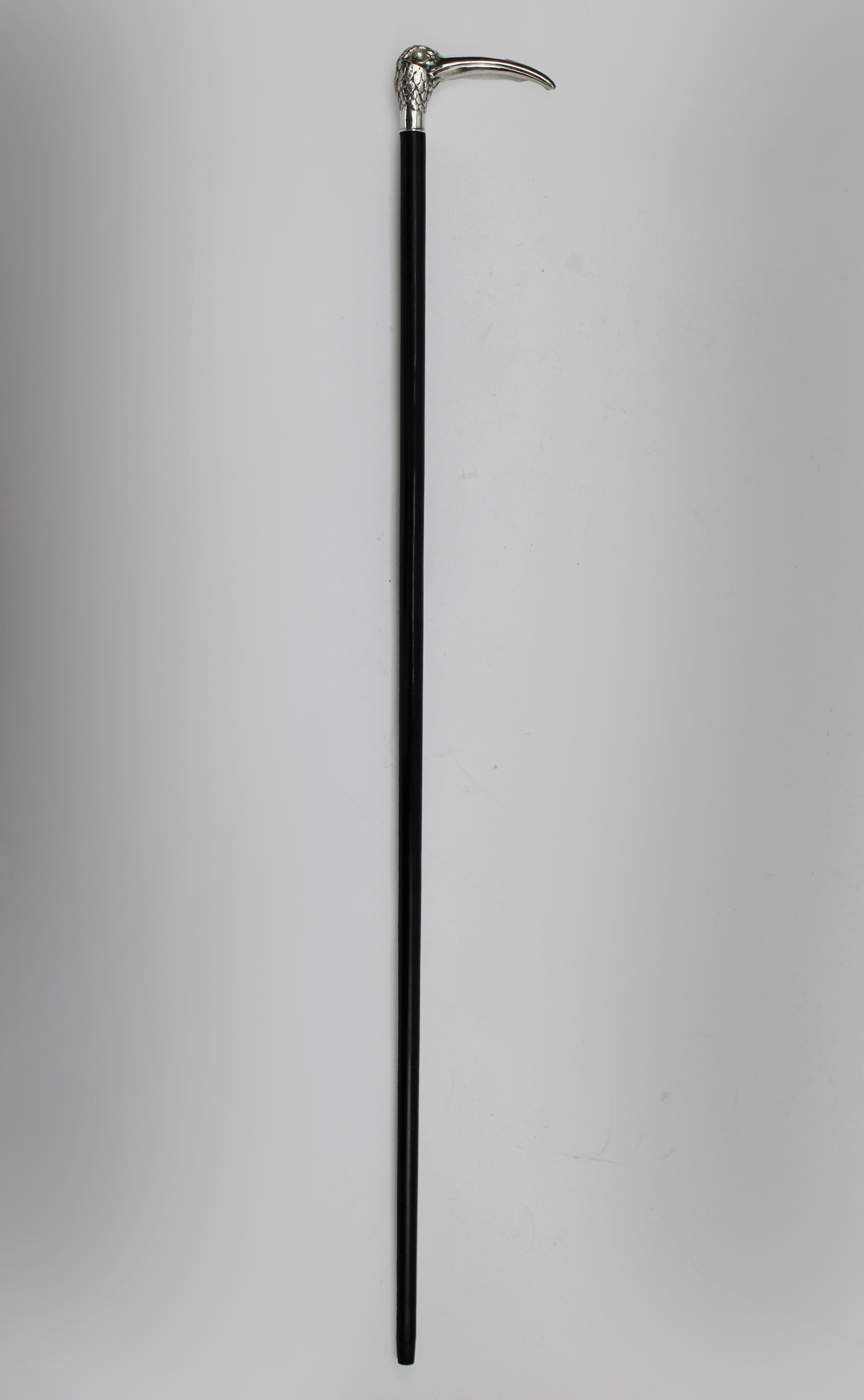 Step back into the beauty and sophistication of the Art Nouveau era with this captivating walking stick, showcasing the naturalistic elegance of an ibis head handle. This unique piece, likely crafted in France and hallmarked at 800-grade silver,