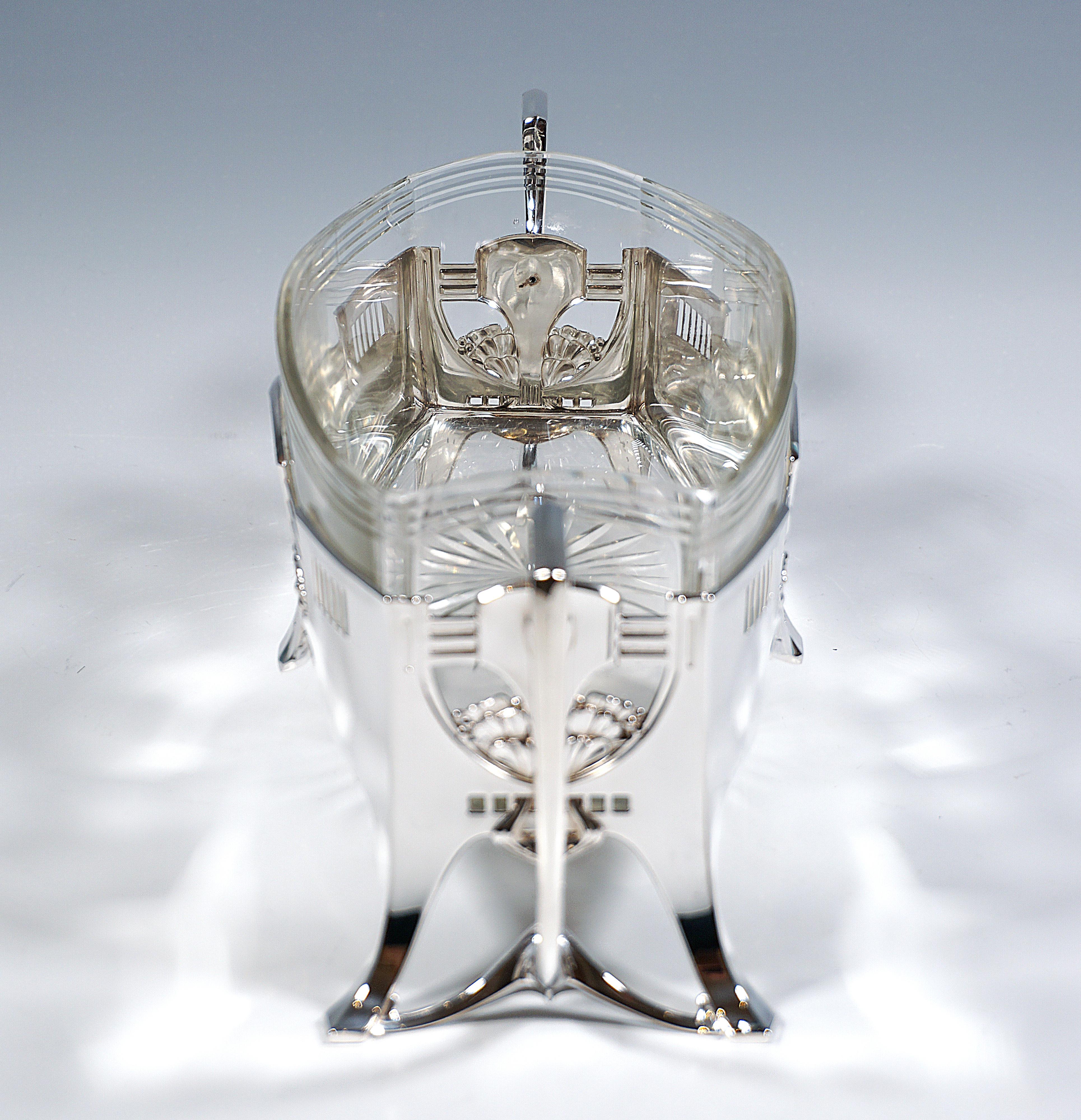Elegant silver jardinière in strict architectural Art Nouveau style, square base with curved long sides, on four flared, smooth feet, geometric and curved openwork elements on all sides intersecting with each other, with delicate, 
loosening floral