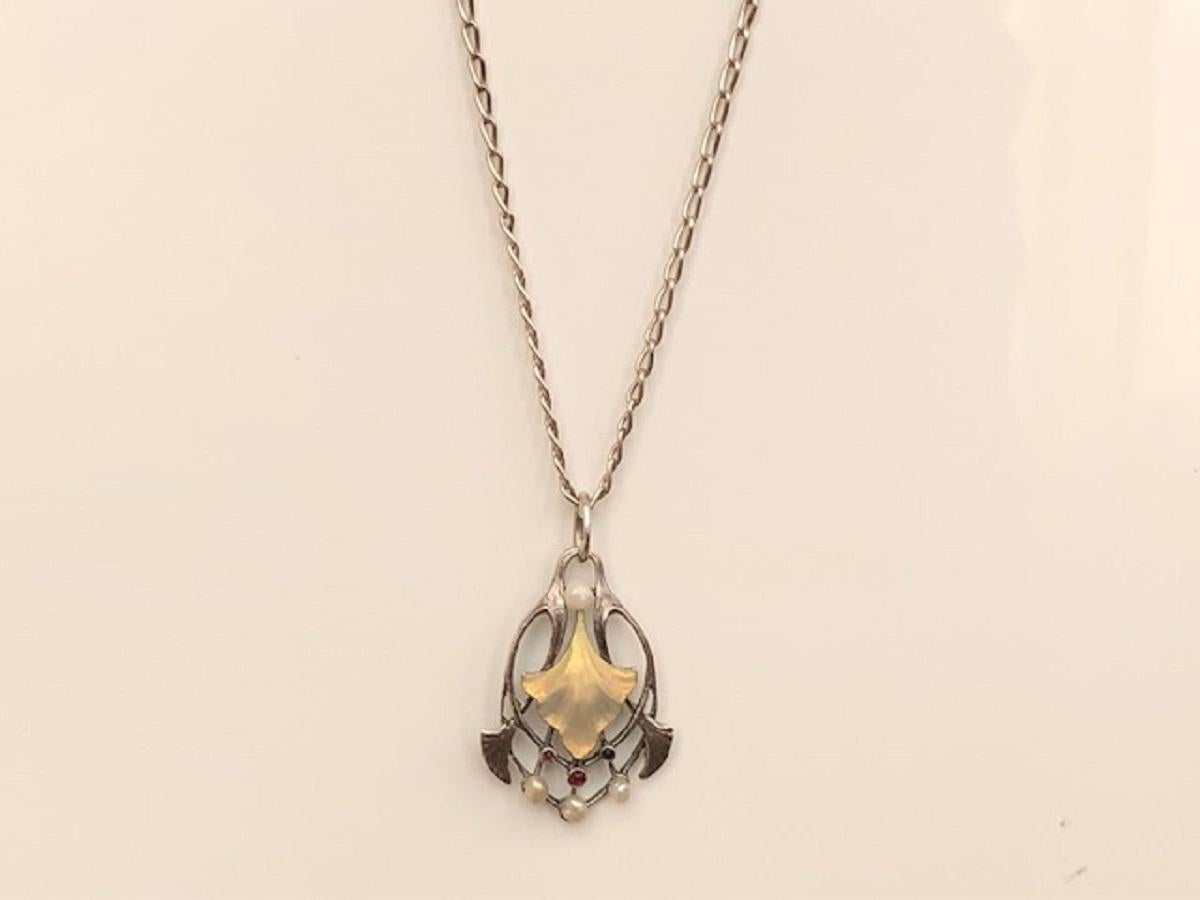 karen has a necklace with a circular pendant