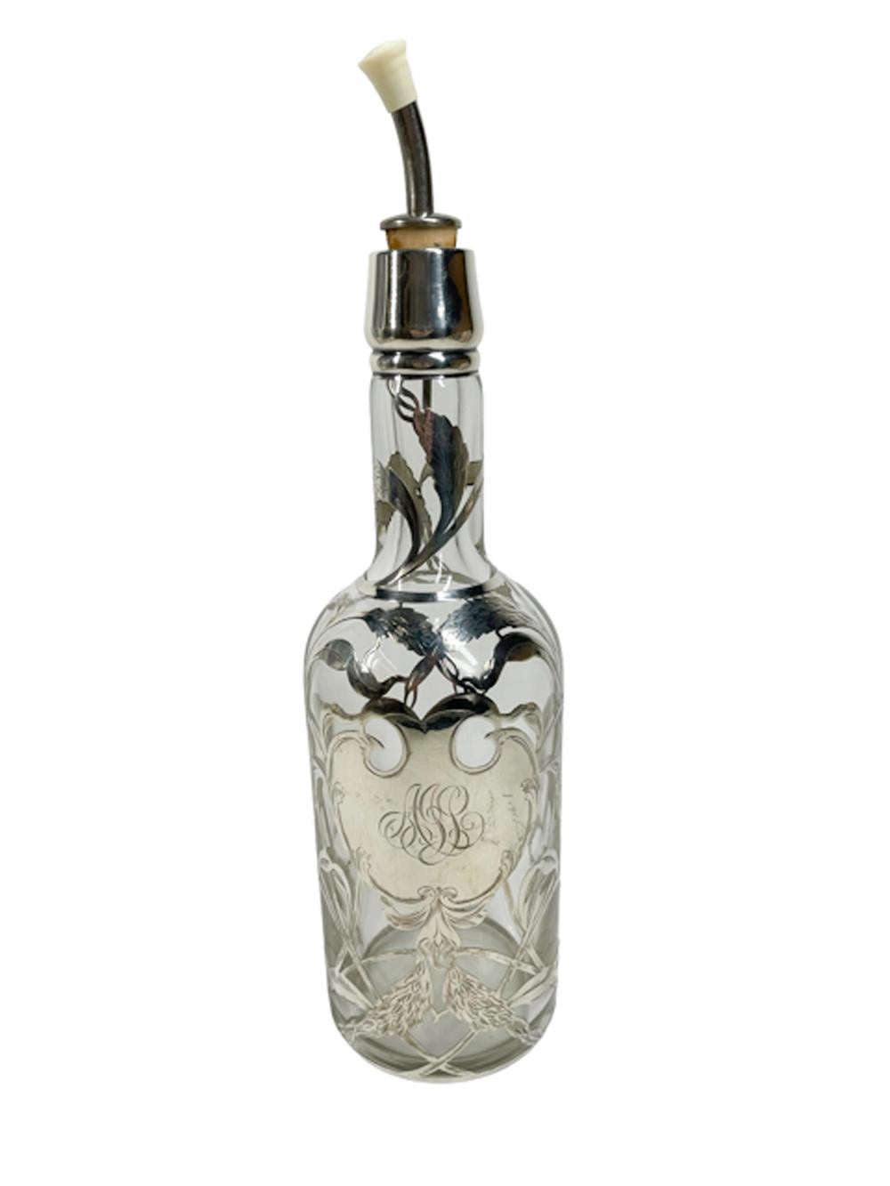 American silver overlay back bar bottle or decanter having an overlaid design of wheat heads around a monogramed cartouche in sterling. The wheat design representing whiskey or rye. Back bar bottles were popular from the end of the 19th century into