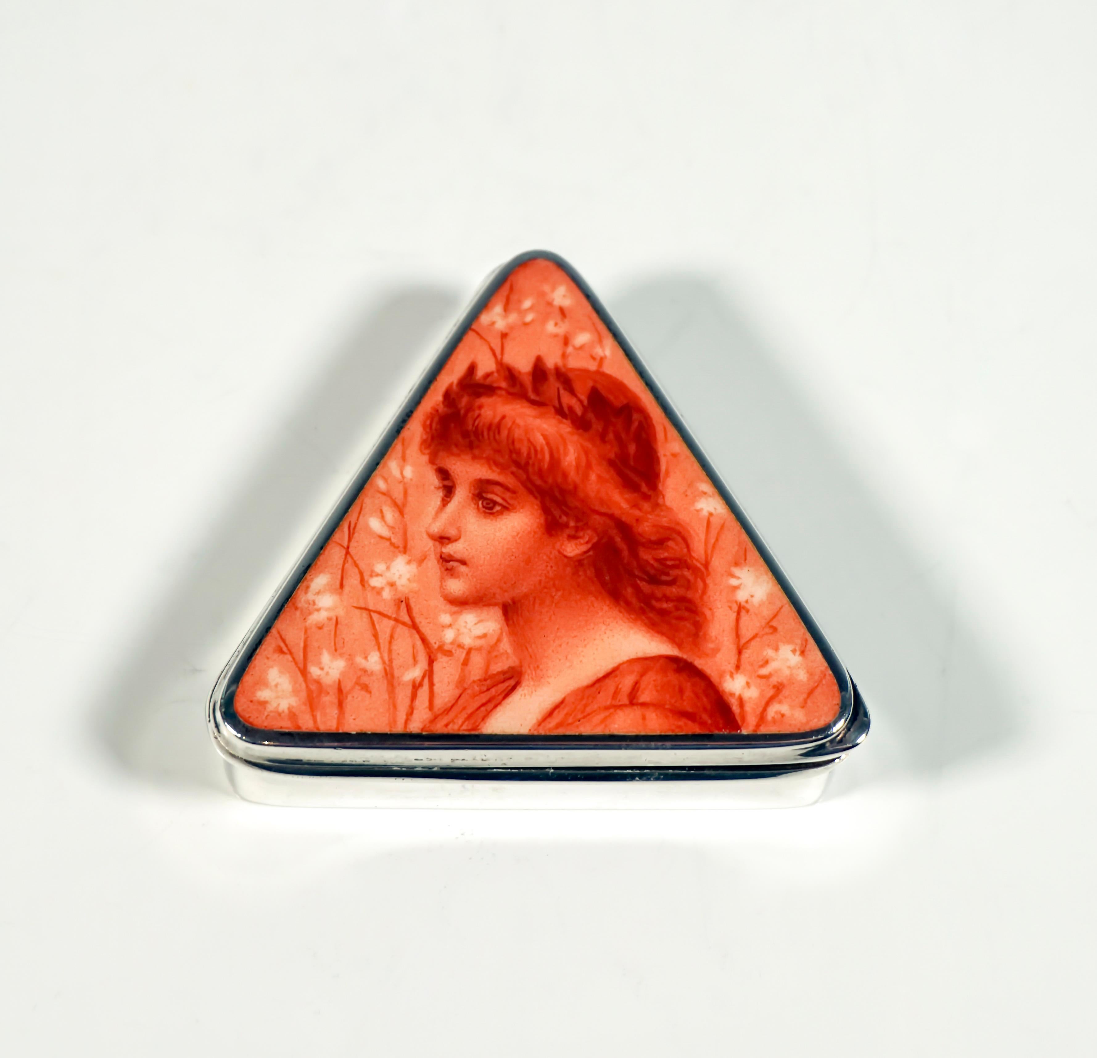 Exquisite Austrian Art-Nouveau silver box, Around 1900:
Triangular silver pill box in a smooth finish with a hinged lid, on the top camaieu enamel painting in iron red: Portrait of a girl with a laurel wreath, opening at the lower right corner,
