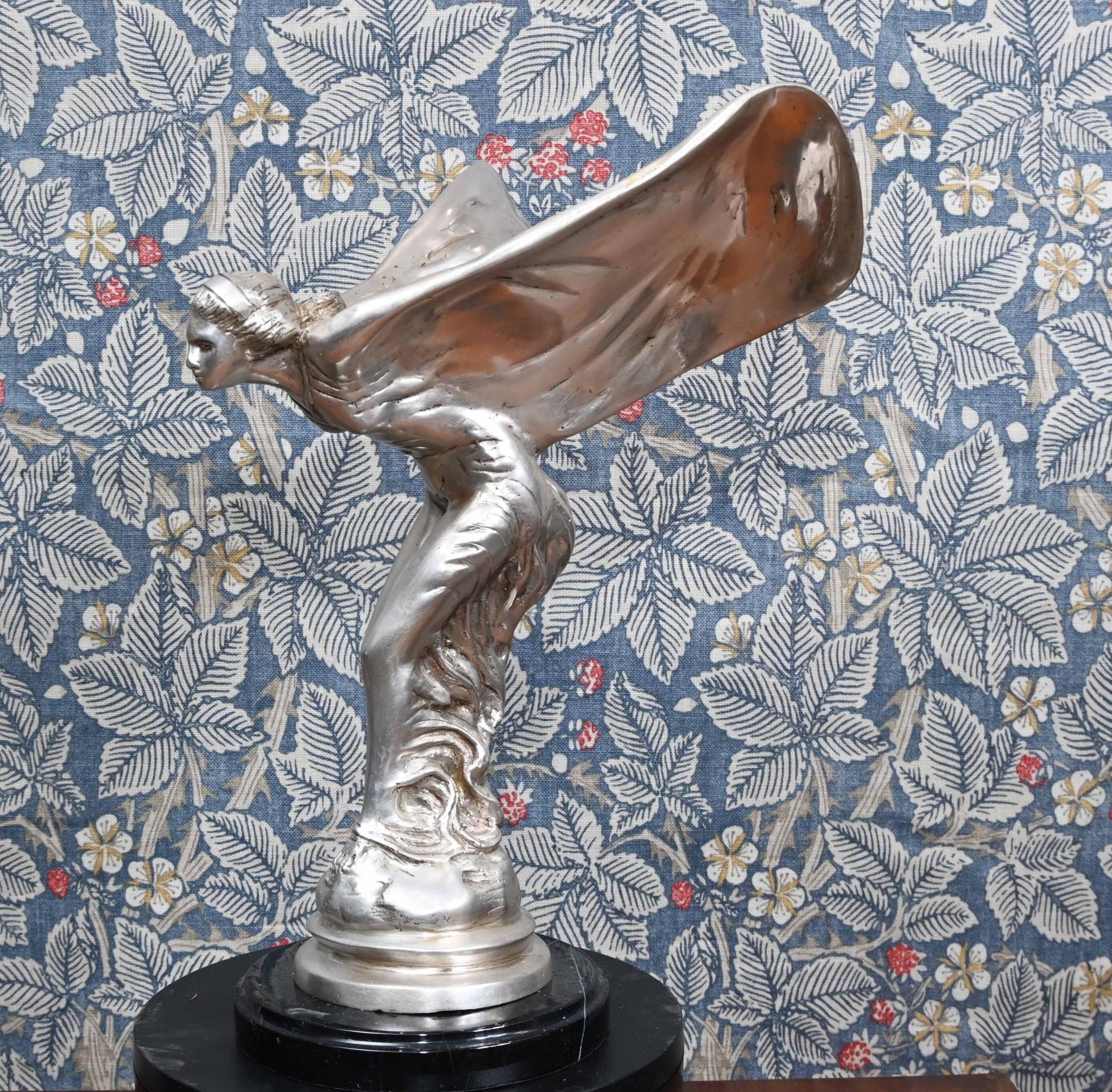 Wonderful silver bronze rendition of the famous Flying Lady statue
Lovely patina to the bronze with silver finish
Stands on the black marble base which is smooth and chip free
Original statue was by Charles Sykes and is considered an art nouveau