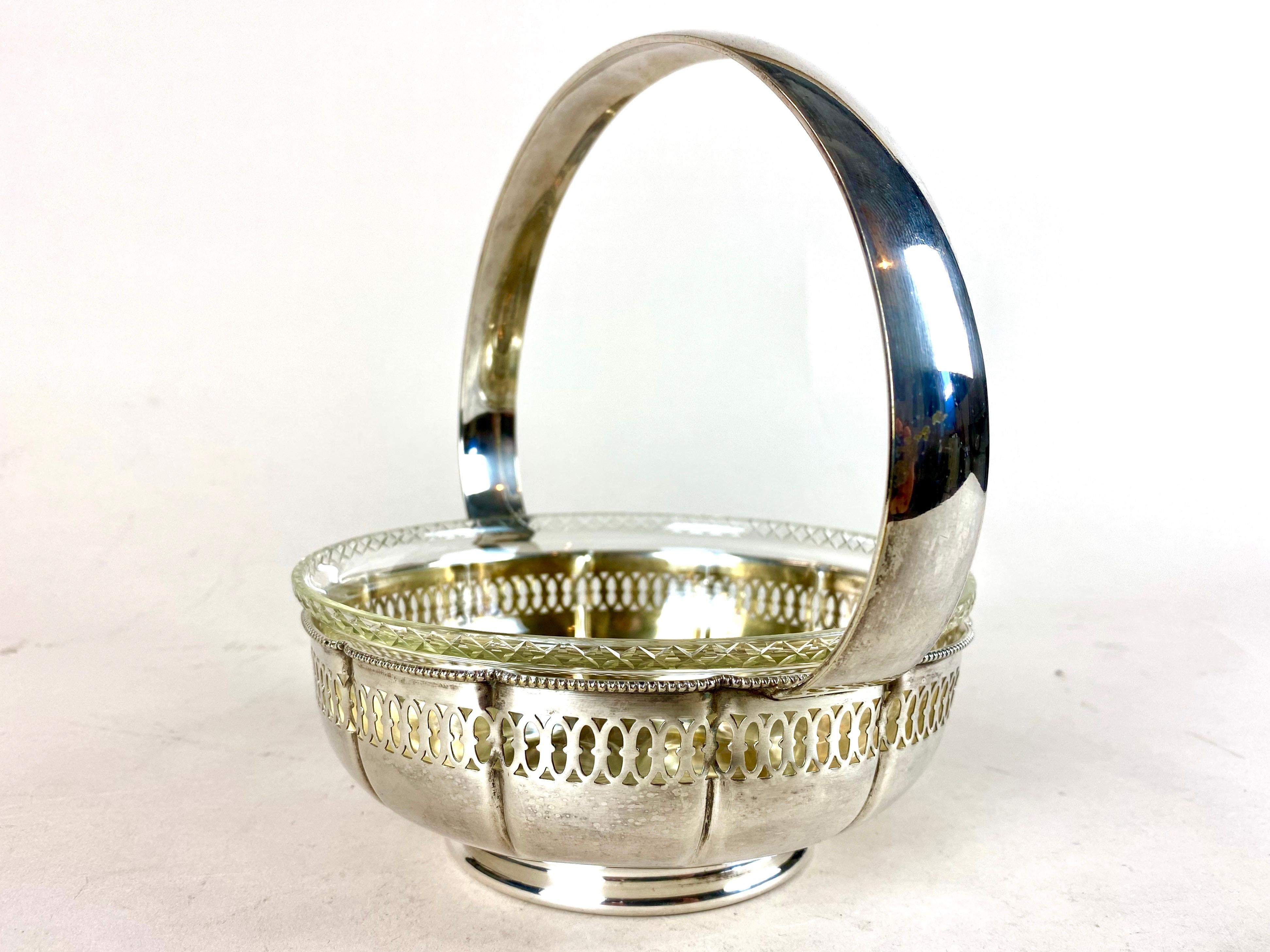 Charming Art Nouveau silvered brass basket/ centerpiece with beautiful glass bowl from the period in Austria around 1910. The silvered, artfully shaped basket impresses with an open worked design and a large. Inside sits a beautiful worked,