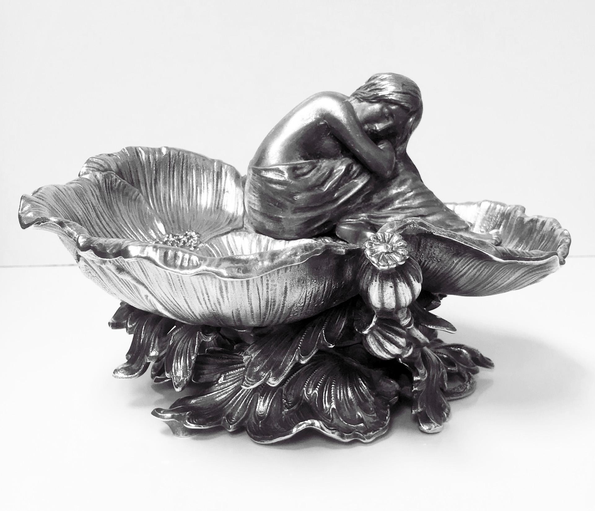 Art Nouveau silver on brass poppy centrepiece vide-poche, French, circa 1900. The centrepiece cast as three open overlapping poppies with sleeping figure of partially clad nymph, naturalistic thistle foliage base numbered 5588T. Measures: