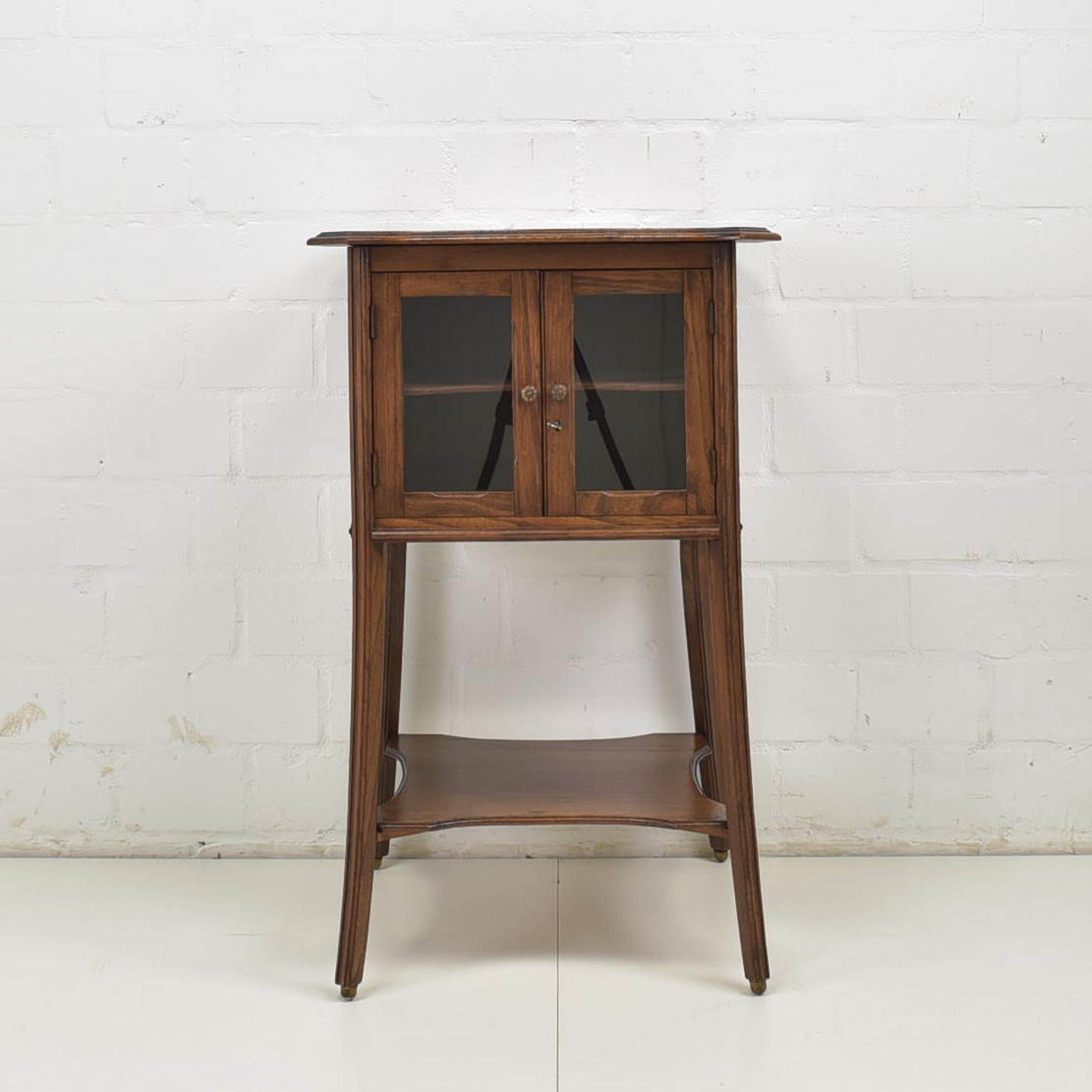 Small showcase restored Art Nouveau around 1920 elm elm side cabinet

Features:
Small, single-door model with glass doors and one shelf
Organic linework
Beautiful patina and grain
Attractive model

Additional information:
Material: Solid