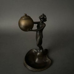 Art Nouveau statuette circa 1900 in pewter or spelter, woman holding a sphere