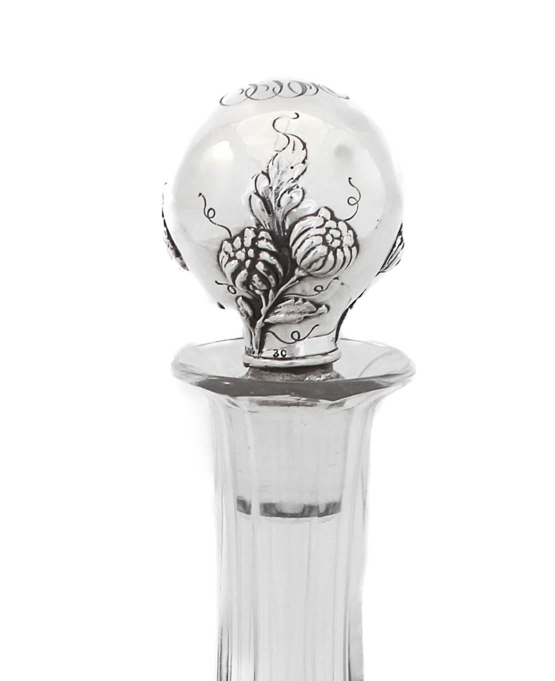 We are thrilled to offer you this sterling silver and crystal decanter made by Gorham Silversmiths of Providence, Rhode Island. The sterling silver stopper is in the Art Nouveau style that was at its most popular. The crystal decanter has a hexagon