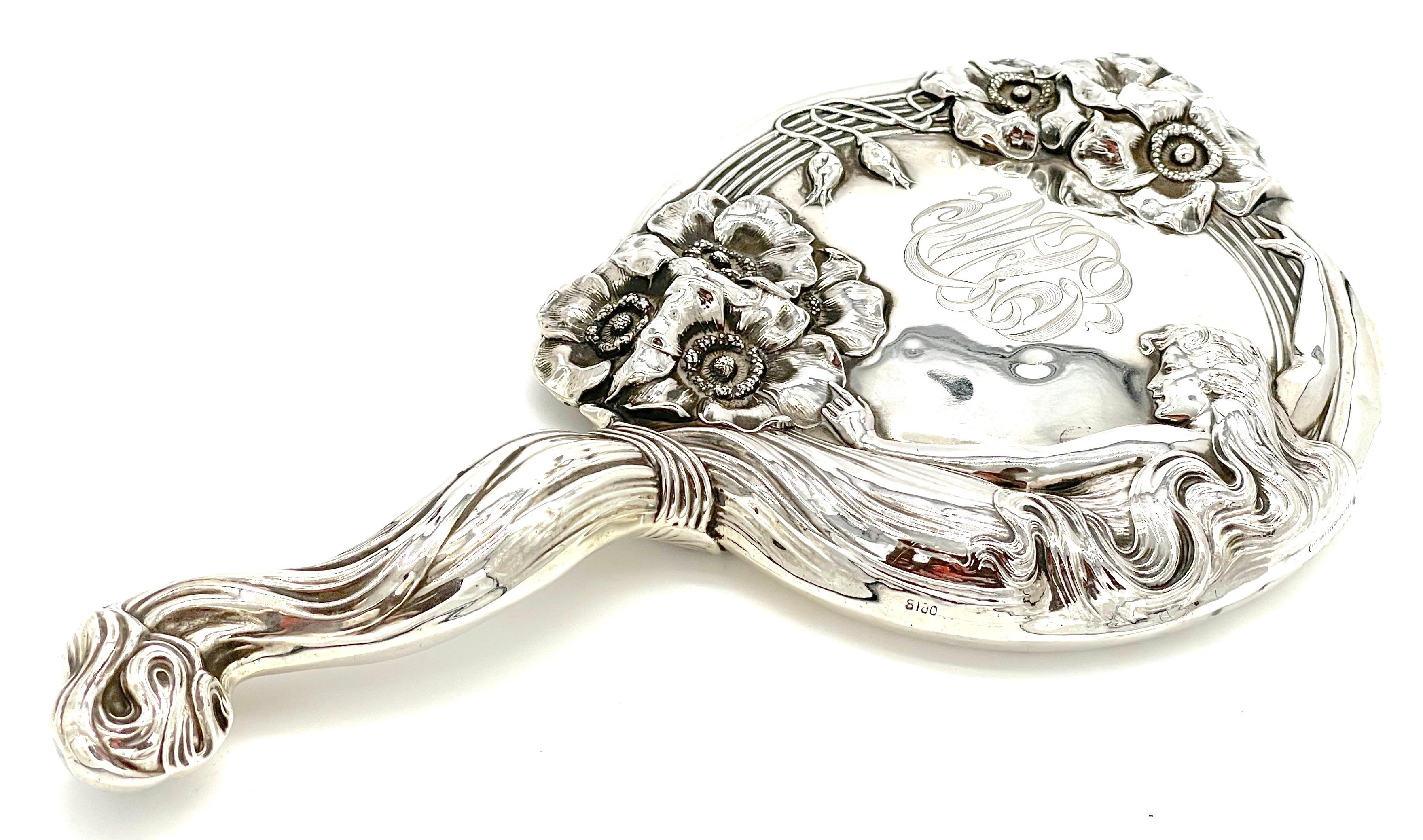 Unger Brothers Art Nouveau Sterling Hand Mirror 'Reine des Fleurs',  (Queen of the Flowers ) C. 1903
USA, Extensively marked for sterling  with the Unger Bros. hallmark (twice) and 925 fine. Pat June 30, 1903 and # 0618

An extraordinary piece of
