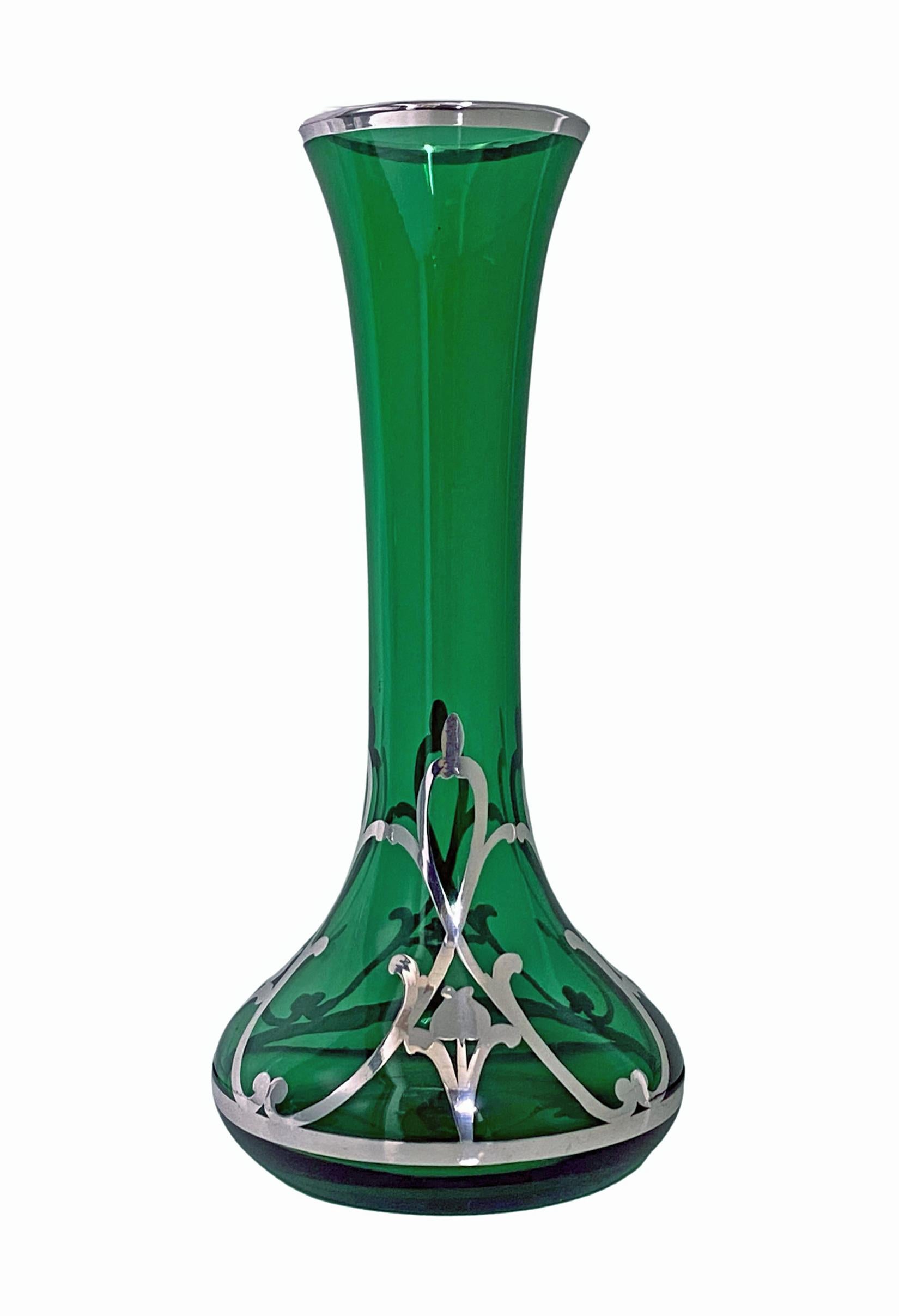 Art Nouveau Sterling overlay green Vase, American C.1910. Tapered bulbous form, the lower section with art nouveau sterling overlay decorative surround, the green glass slightly tapering to everted sterling mounted rim. Signed Sterling. Height:7.5