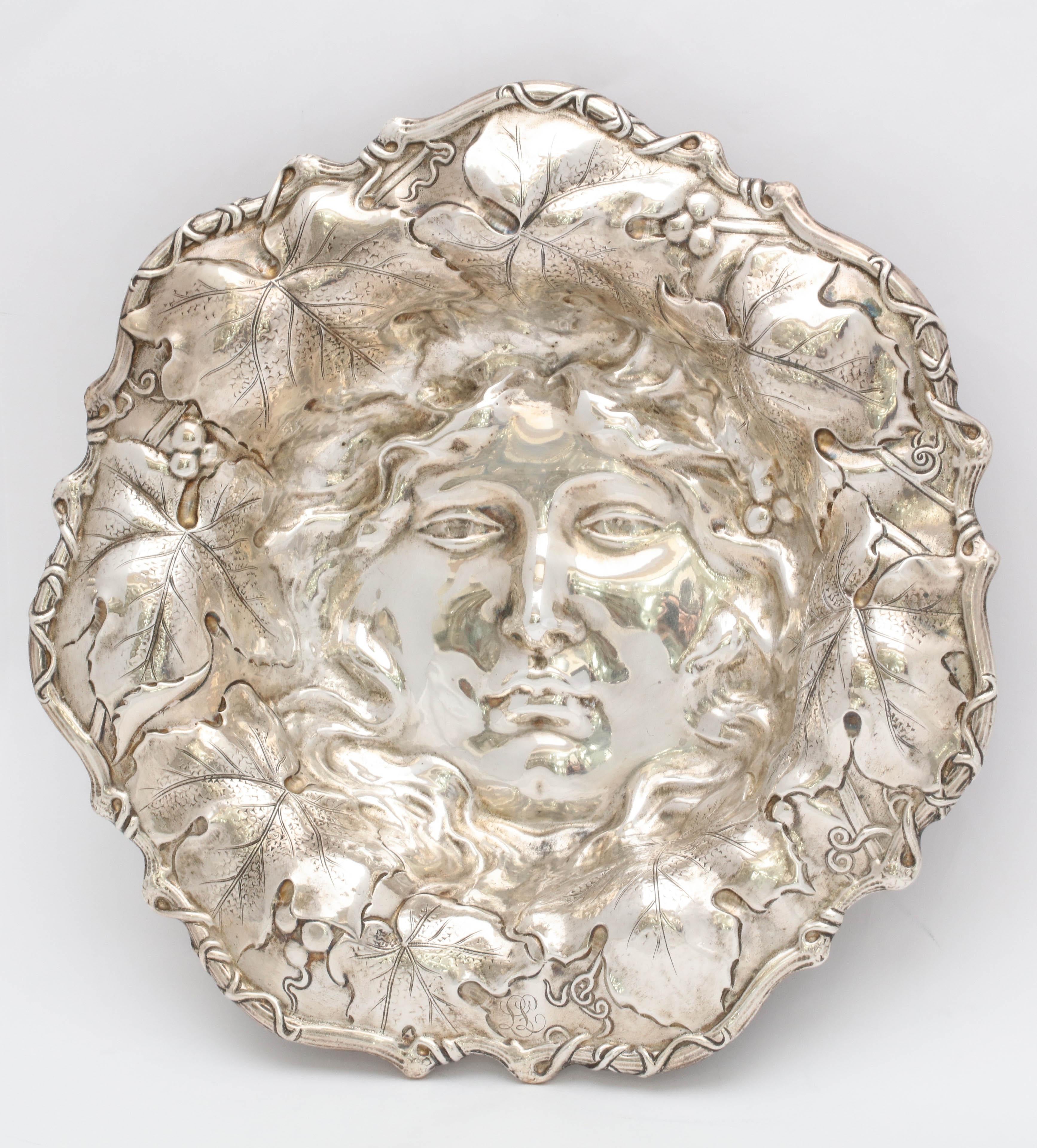 Art Nouveau, sterling silver bowl, in the form of a woman's face (which takes up the centre of the bowl), Whiting Mfg., Co., Providence, Rhode Island, circa 1900. The woman's face is surrounded by her long, flowing hair, grape leaves and vines which