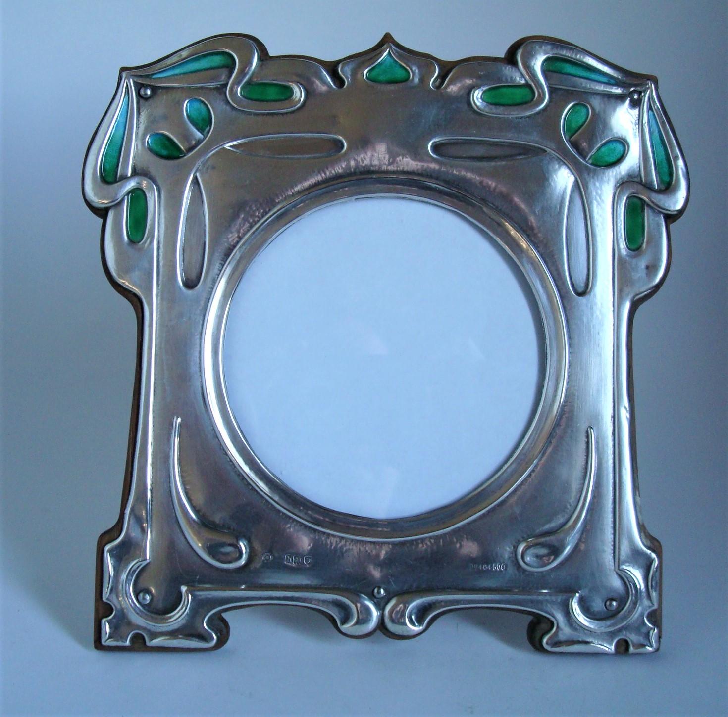 Art Nouveau - Art & craft sterling silver enamel photograph frame - William Hutton & Sons 1903.
William Hutton & Sons silver and enamel square photo frame, the design attributed to Kate Allen.

The frame is in very good condition with original