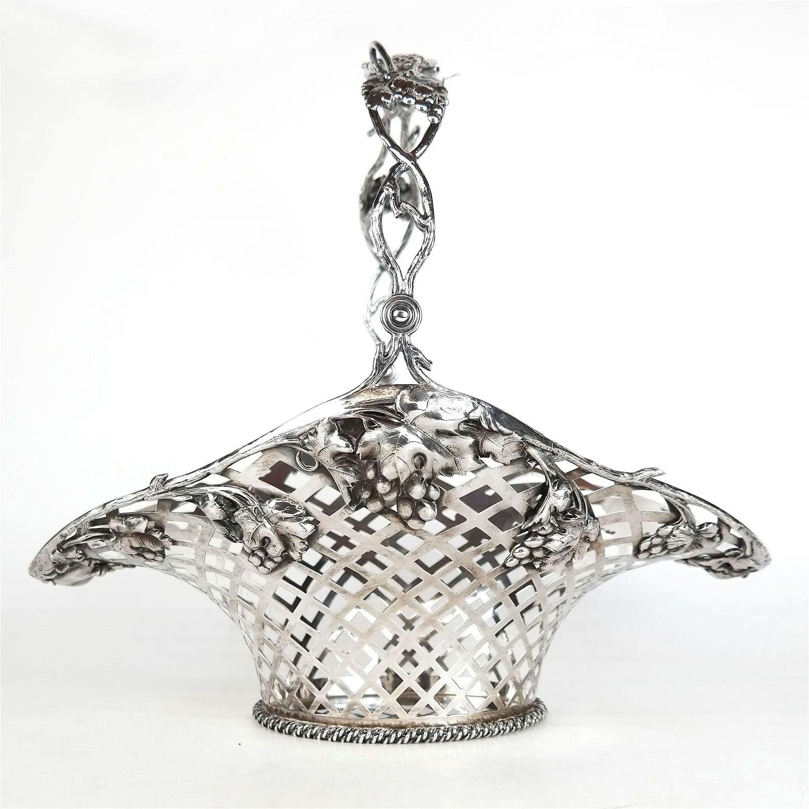 Our large reticulated fruit basket by Mauser Mfg. Co. of New York, circa 1900s, is distinguished by its large size and finely sculpted handle and rim decorated with grapevine motifs. Underside with the maker's mark, style number and STERLING. 47.5