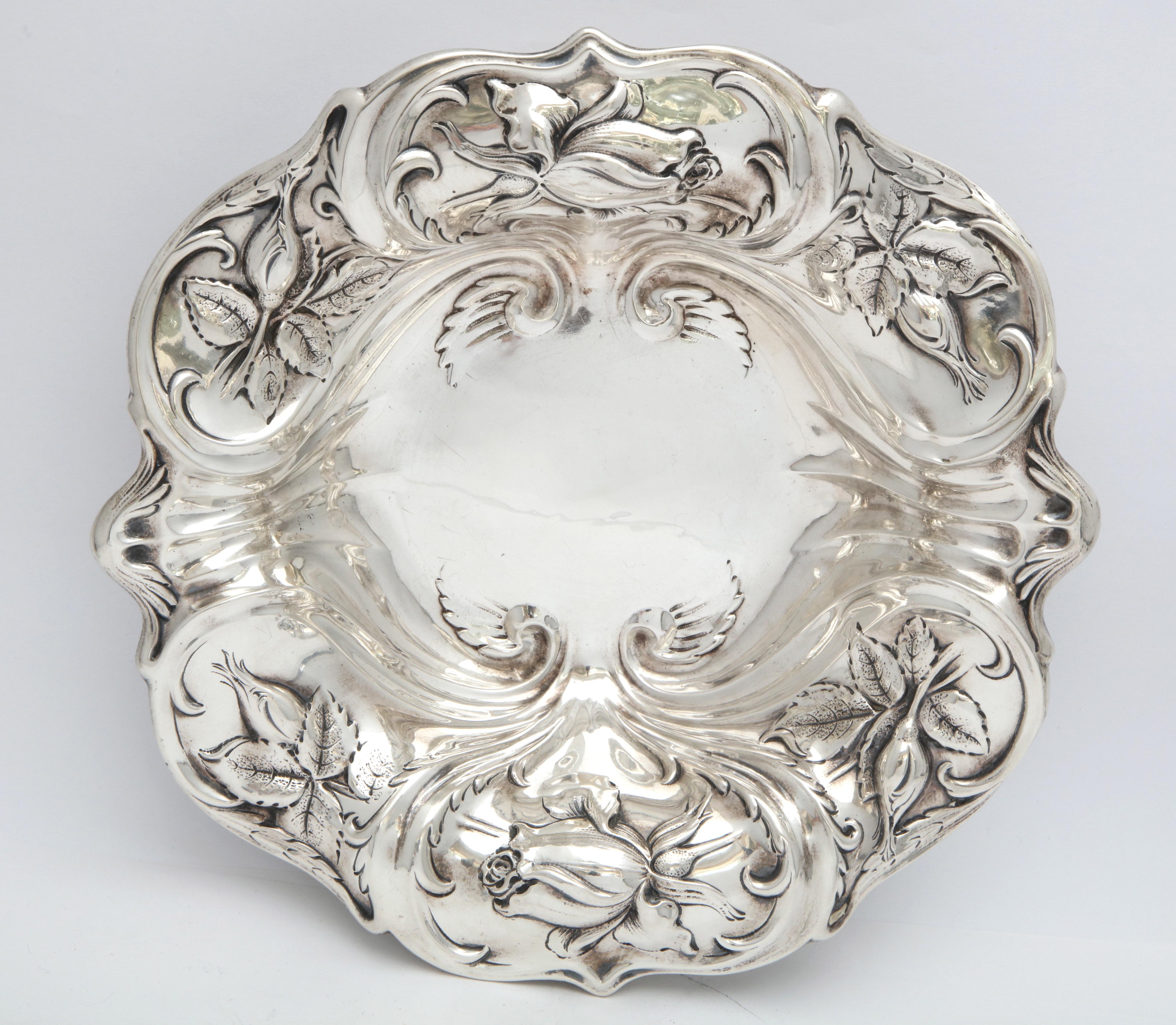 Art Nouveau, sterling silver serving bowl, Whiting Mfg. Co., Providence, Rhode Island, circa 1895. Blown out roses and rose buds decorate the bowl, their stems whipping around the bowl. Measures 9 inches in diameter x 2 inches high. Weighs 6.650