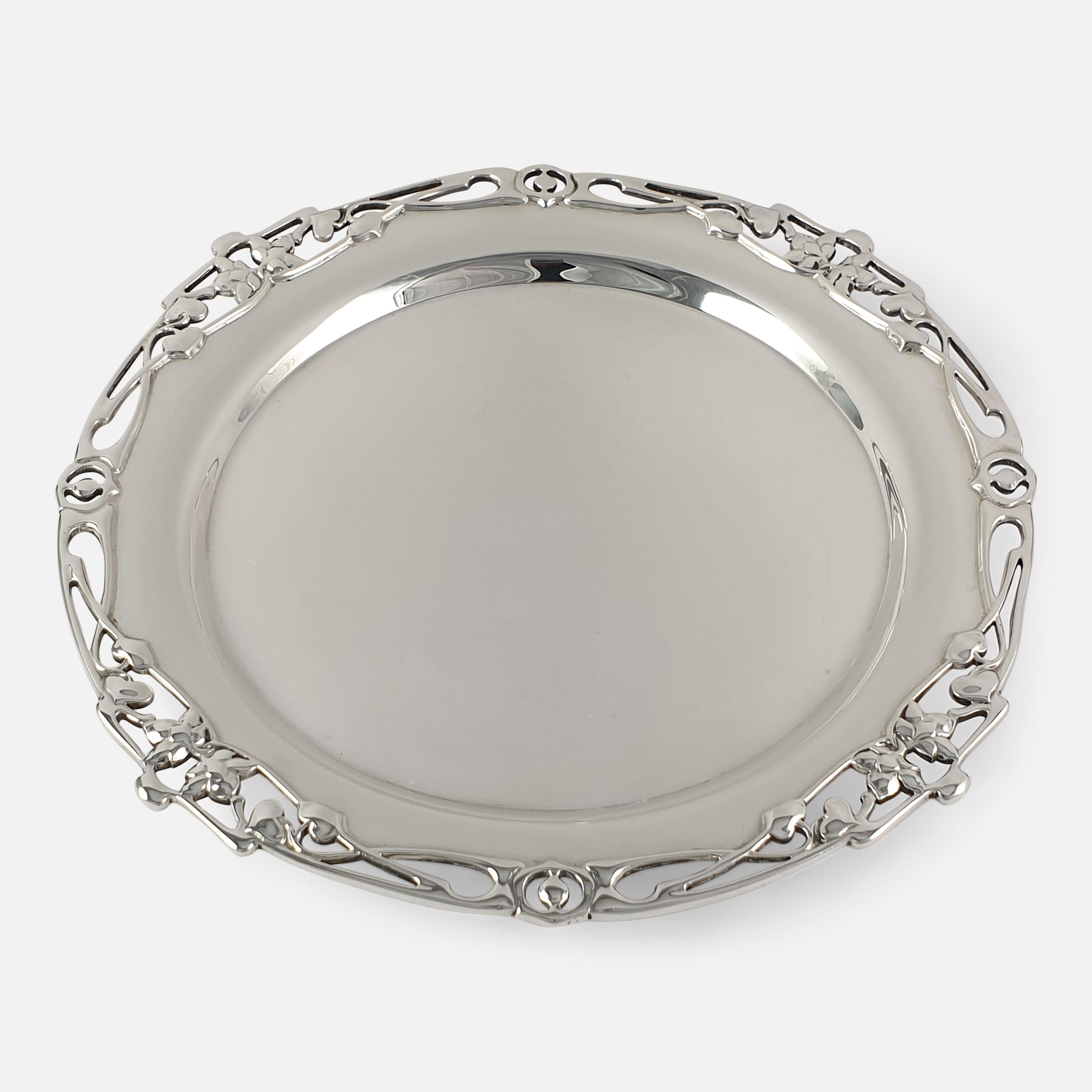An Edwardian Art Nouveau silver salver by William Hutton & Sons, Sheffield, 1906. The salver is of circular form, with a pierced foliate border sitting on three feet.

The hallmarks are located to the reverse with the makers mark of William Hutton &