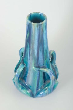 Art Nouveau stoneware vase with sculptural details and blue and green glaze.