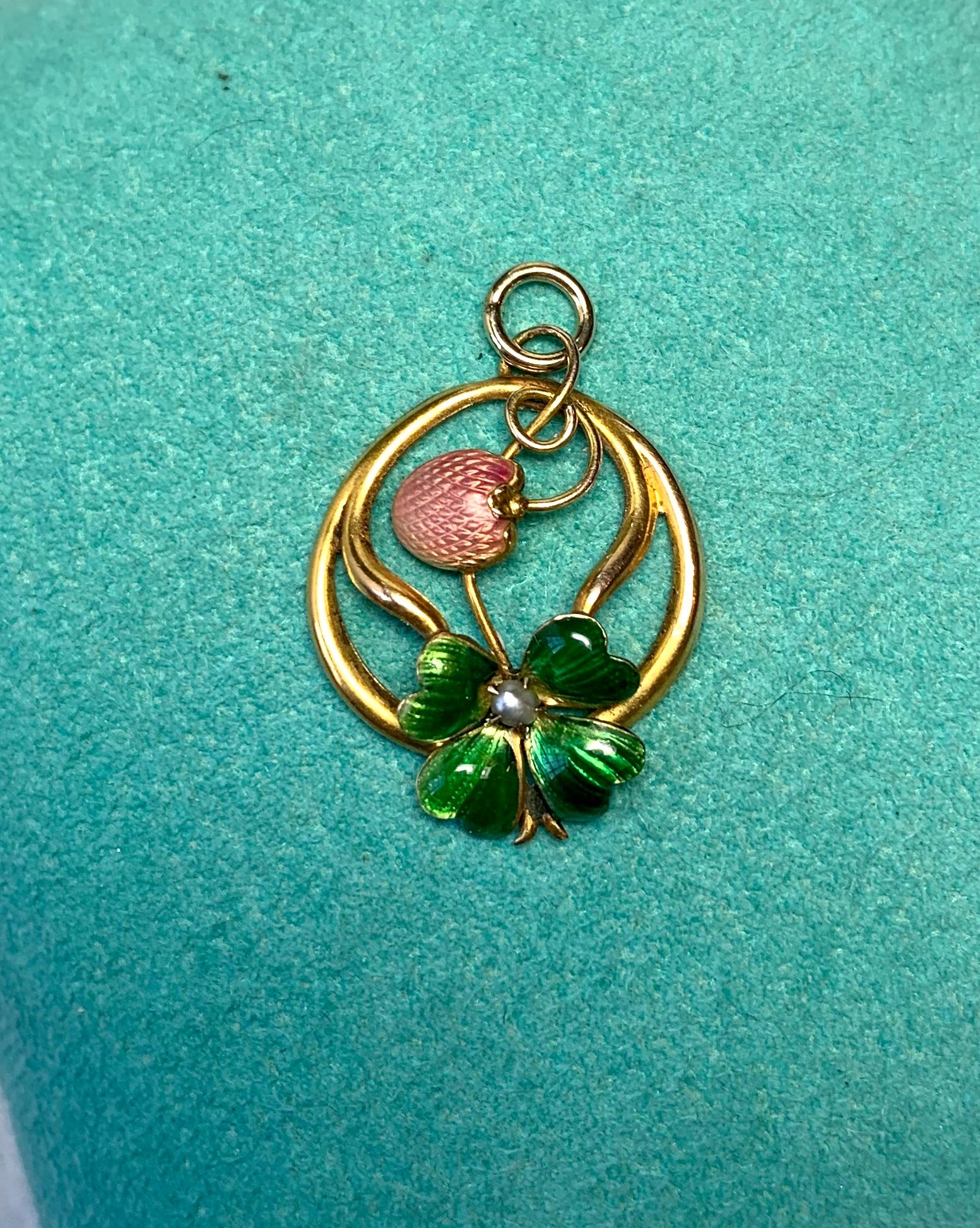 A VICTORIAN - ART NOUVEAU PENDANT IN THE FORM OF AN ENTWINED STRAWBERRY AND A LUCKY FOUR LEAF CLOVER WITH A CENTRAL PEARL AND THE MOST SPECTACULAR GREEN AND RED DETAILED ENAMEL OF THE HIGHEST QUALITY.  WITH BEAUTIFUL GOLD WORK IN 10 KARAT GOLD AND