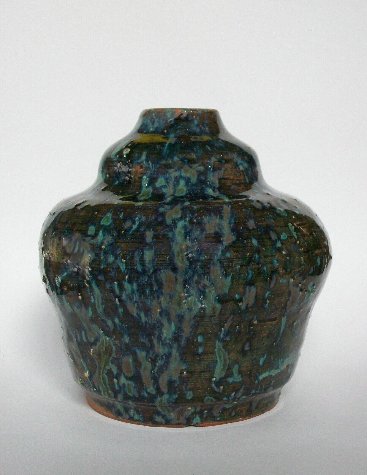 Art Nouveau studio pottery vase - wheel thrown terracotta - clear green glaze with blue opalescent splash - unsigned - country of origin unknown - early 20th century.

Excellent vintage condition - minor flea bite/glaze chips to the rim -