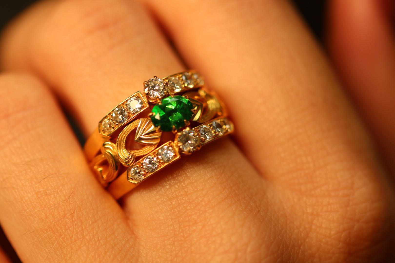 This absolutely mesmerising ring captures the Art Nouveau style wonderfully, the beautiful flowing scroll motif in rich 18 karat gold against the vivid green colour of the demantoid garnet which measures at 0.81ct (6.1mm x 4.5mm x 2.8mm).

Bordering
